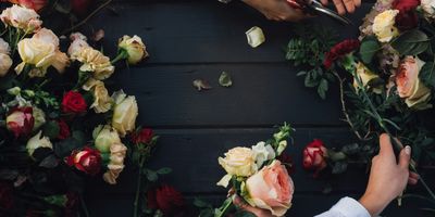 Florist inspecting and arranging fresh roses — quality assessment