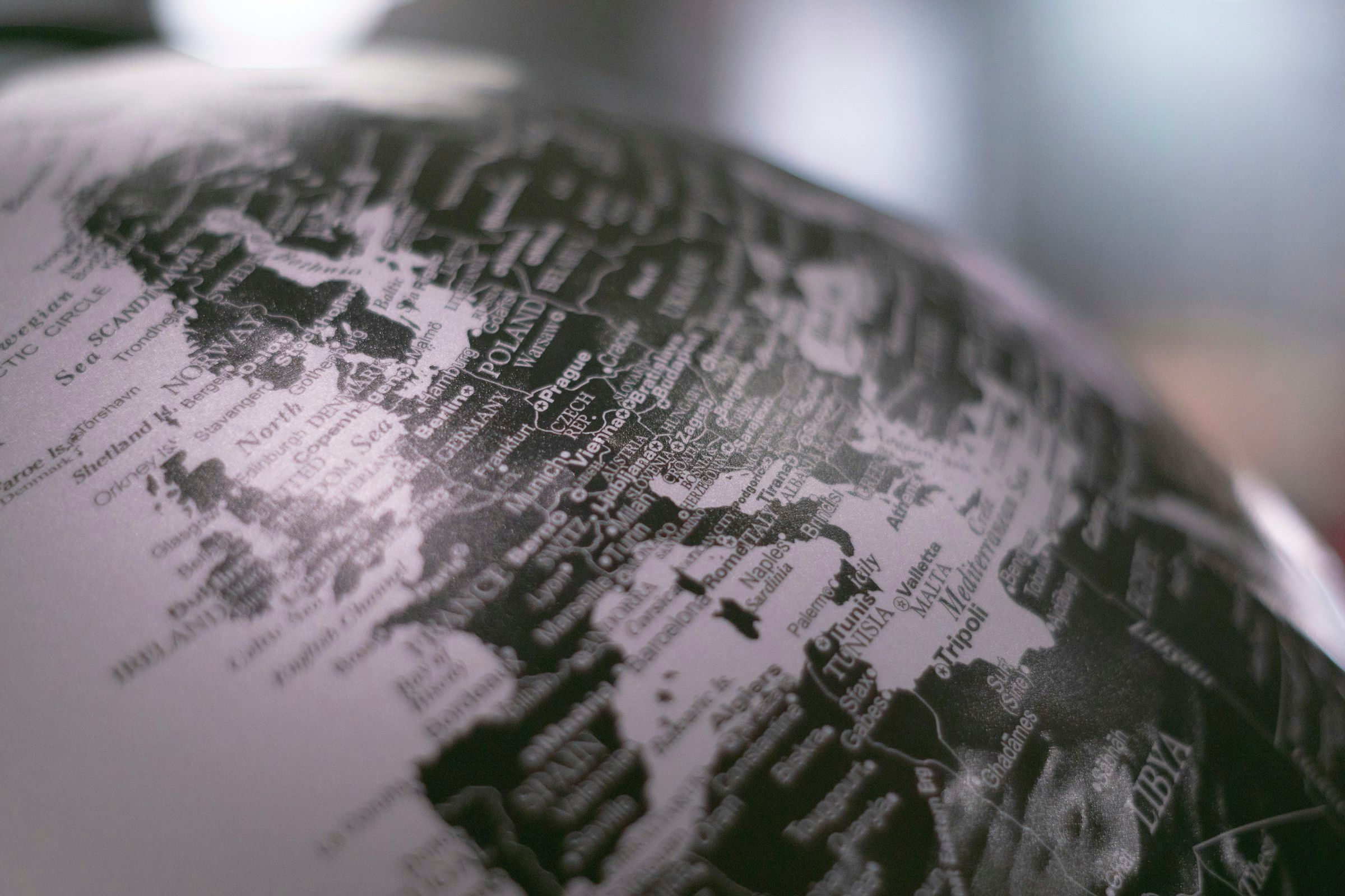 grayscale photo of desk globe