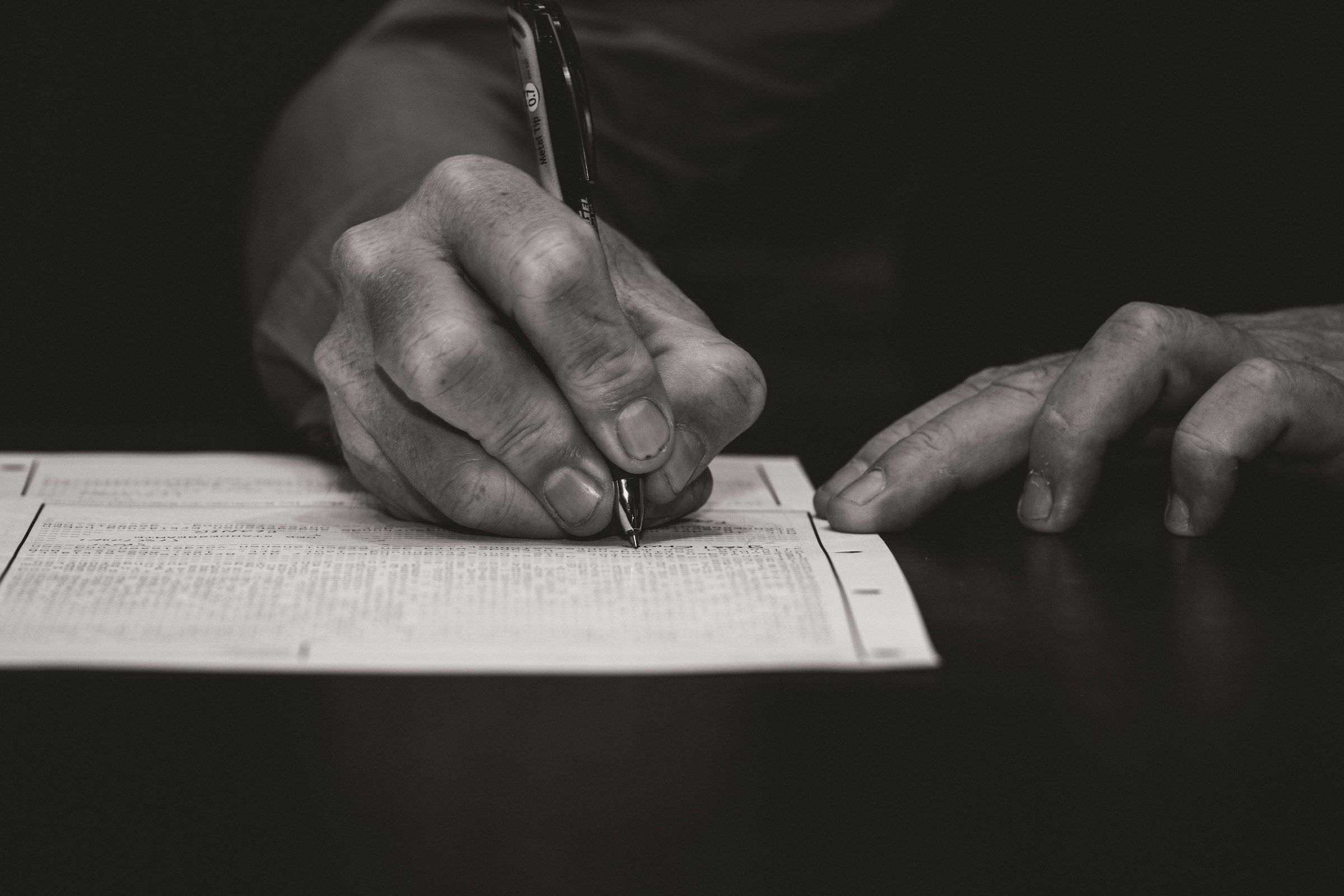 Hand writing with a fountain pen on paper.