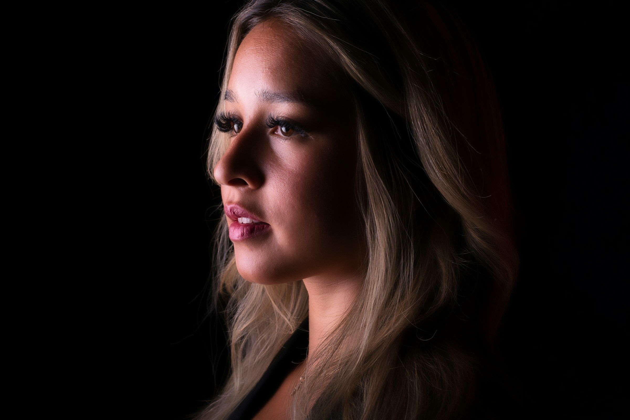 woman with red lipstick and black mascara