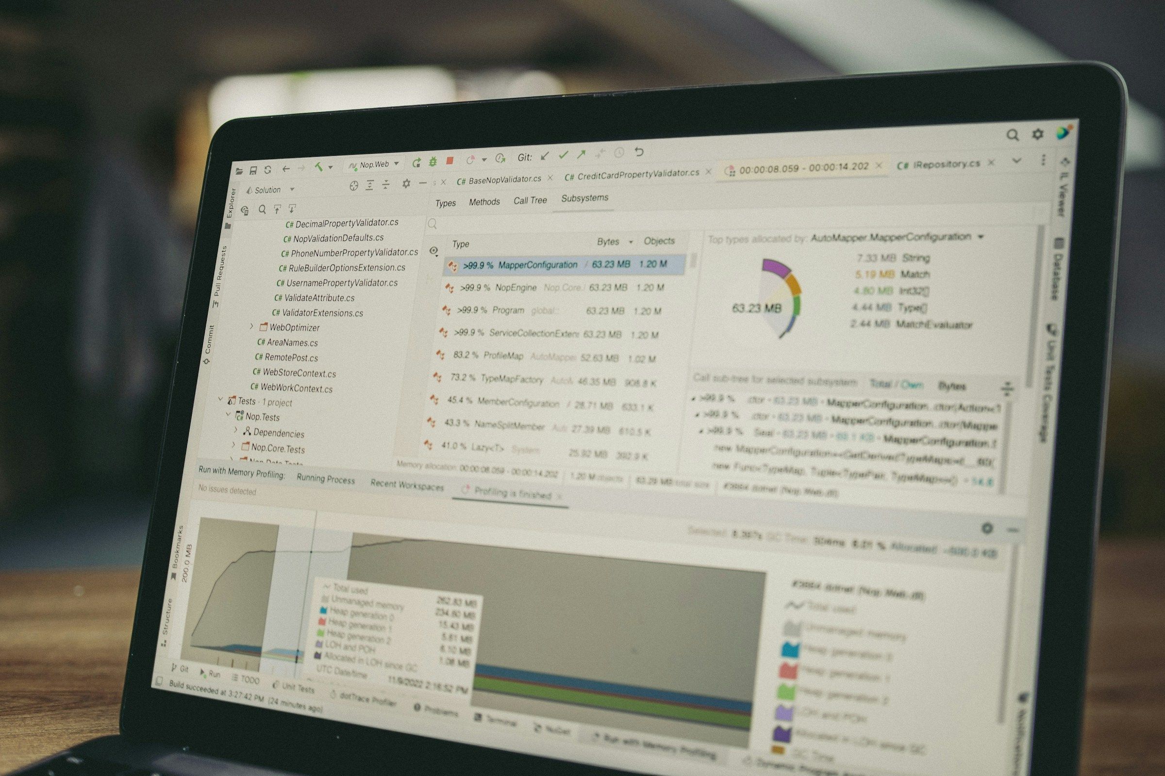 Laptop screen displaying code and data charts.