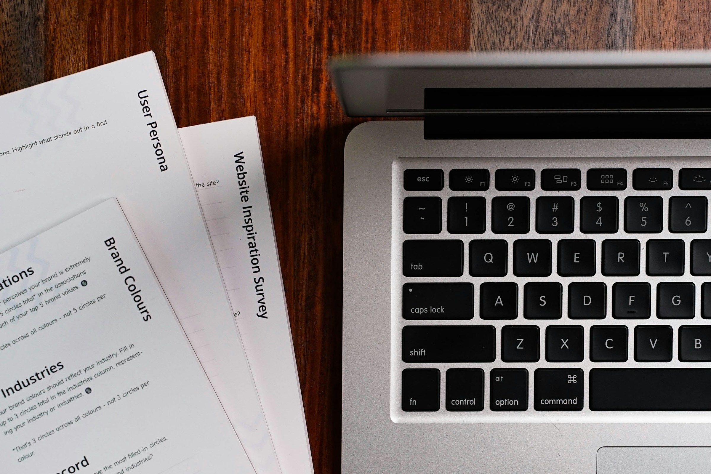 Person reviewing legal documents beside laptop with AI adult content policy checklist visible