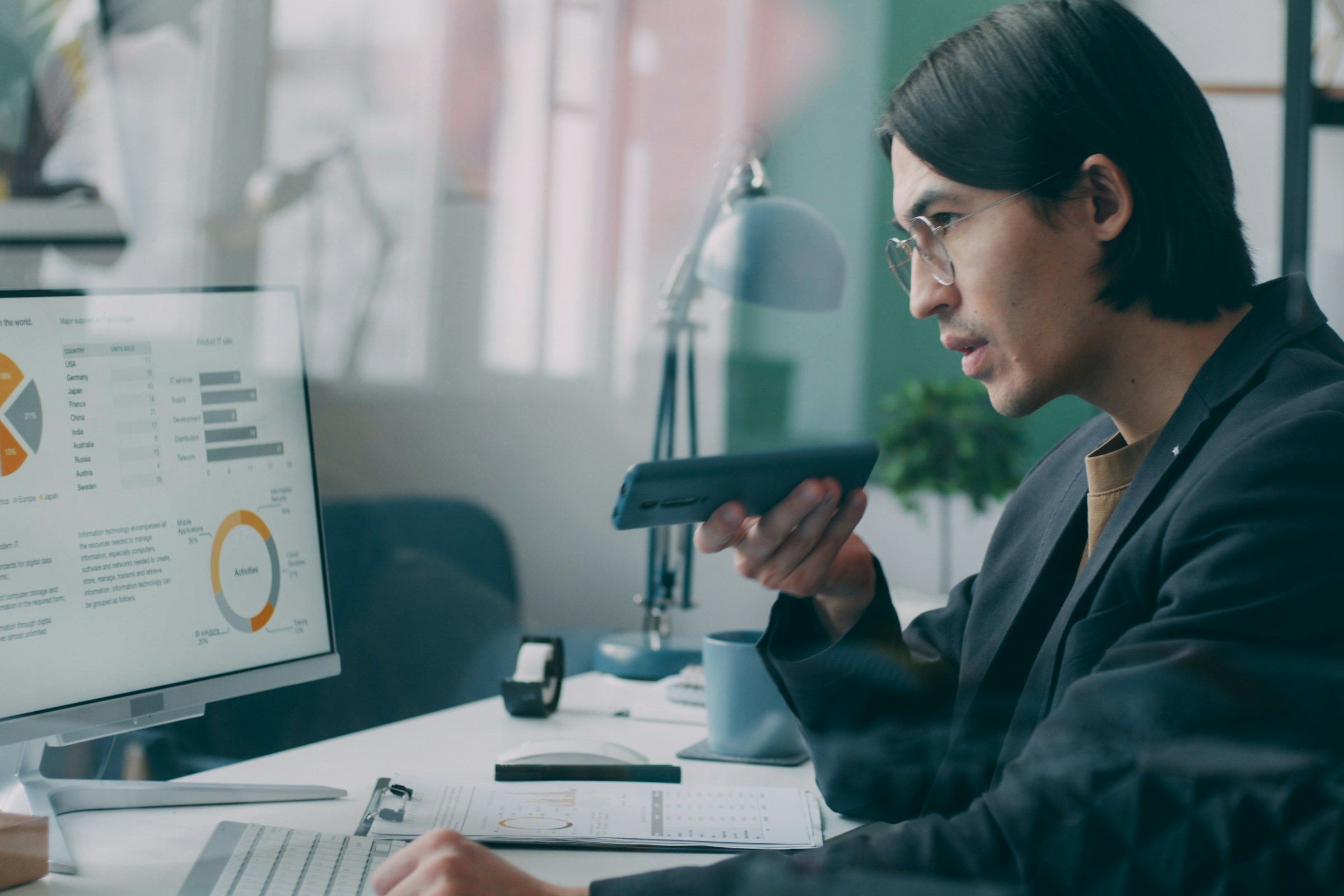 A woman sitting at a desk in front of a computer