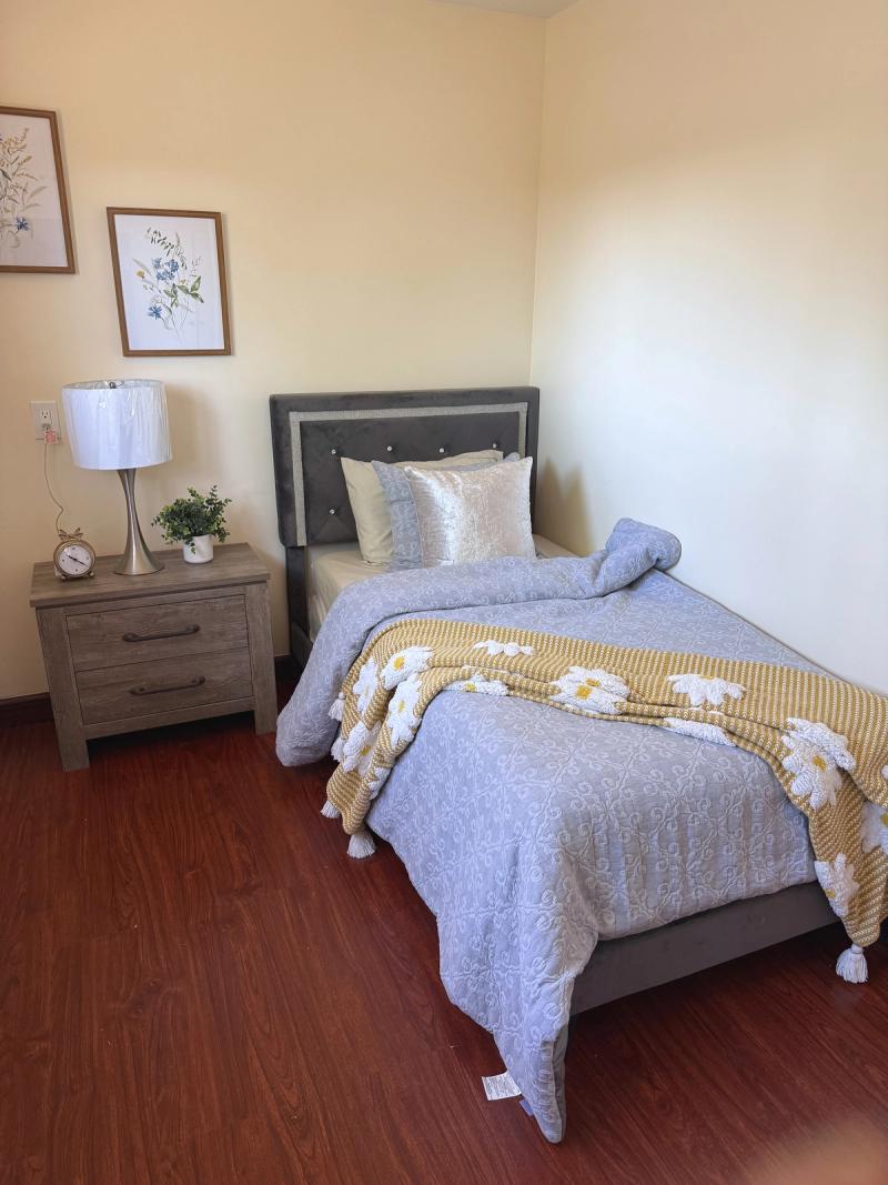 Resident bedroom with bed and natural light