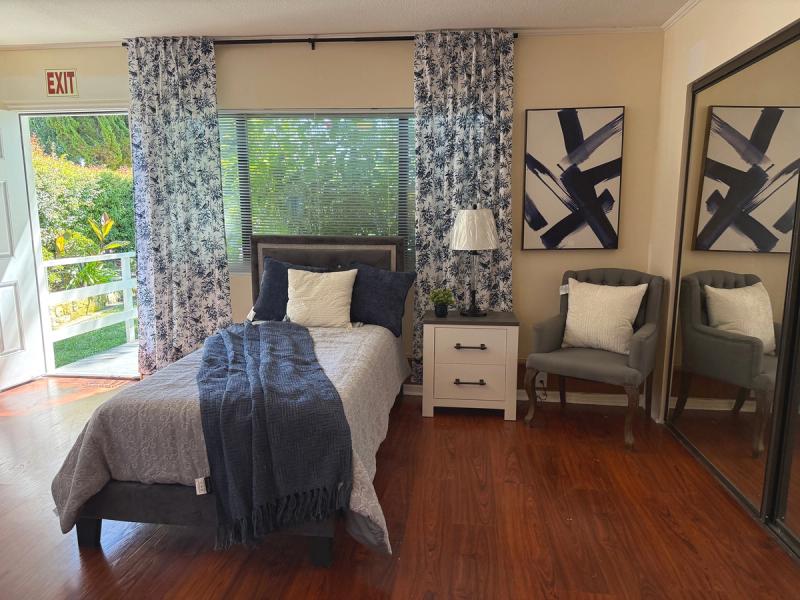 Resident bedroom with a doorway to the garden