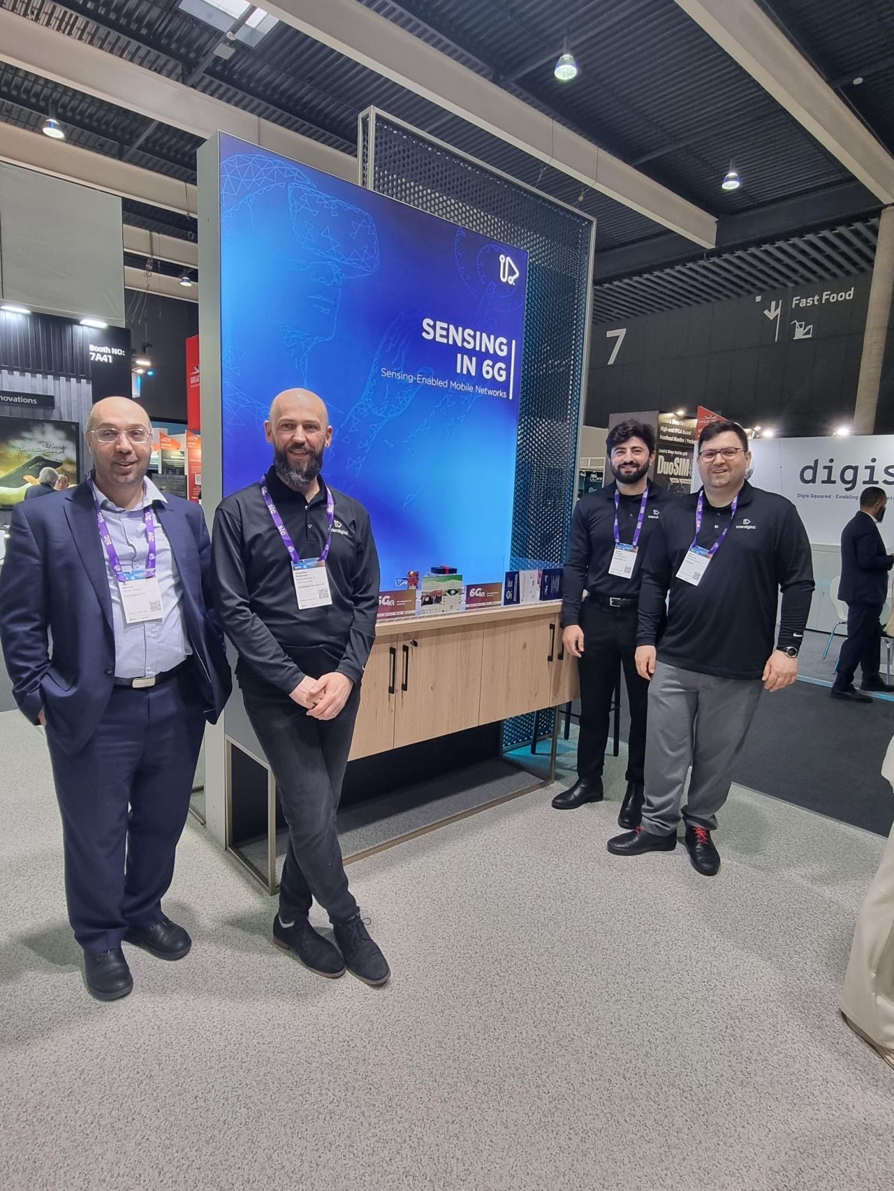 People standing around a screen