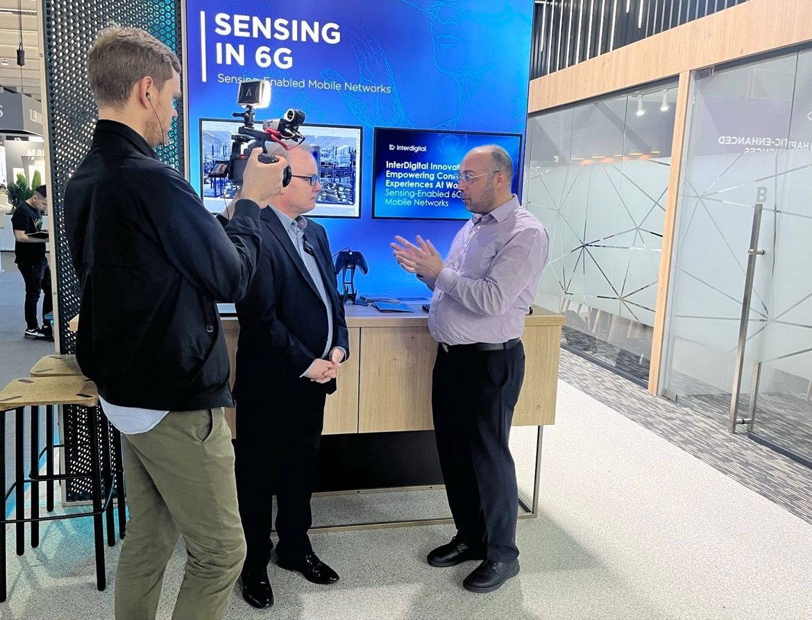 People talking in front of a screen