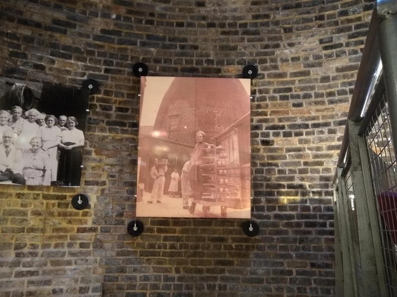 A large sepia photo on the wall inside a bottle kiln