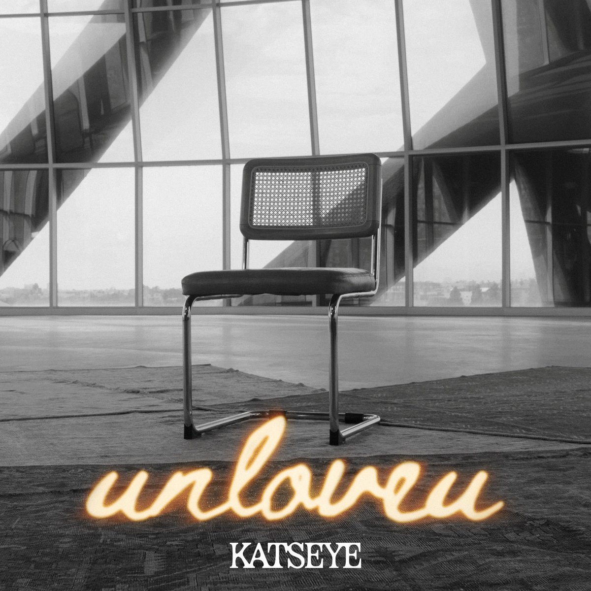 Imagem oficial de Unloveu com cadeira vazia e título da música