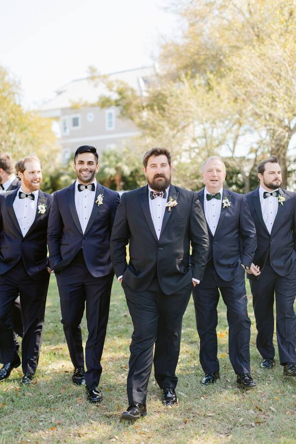 Real wedding, groom in a black peak-lapel tuxedo