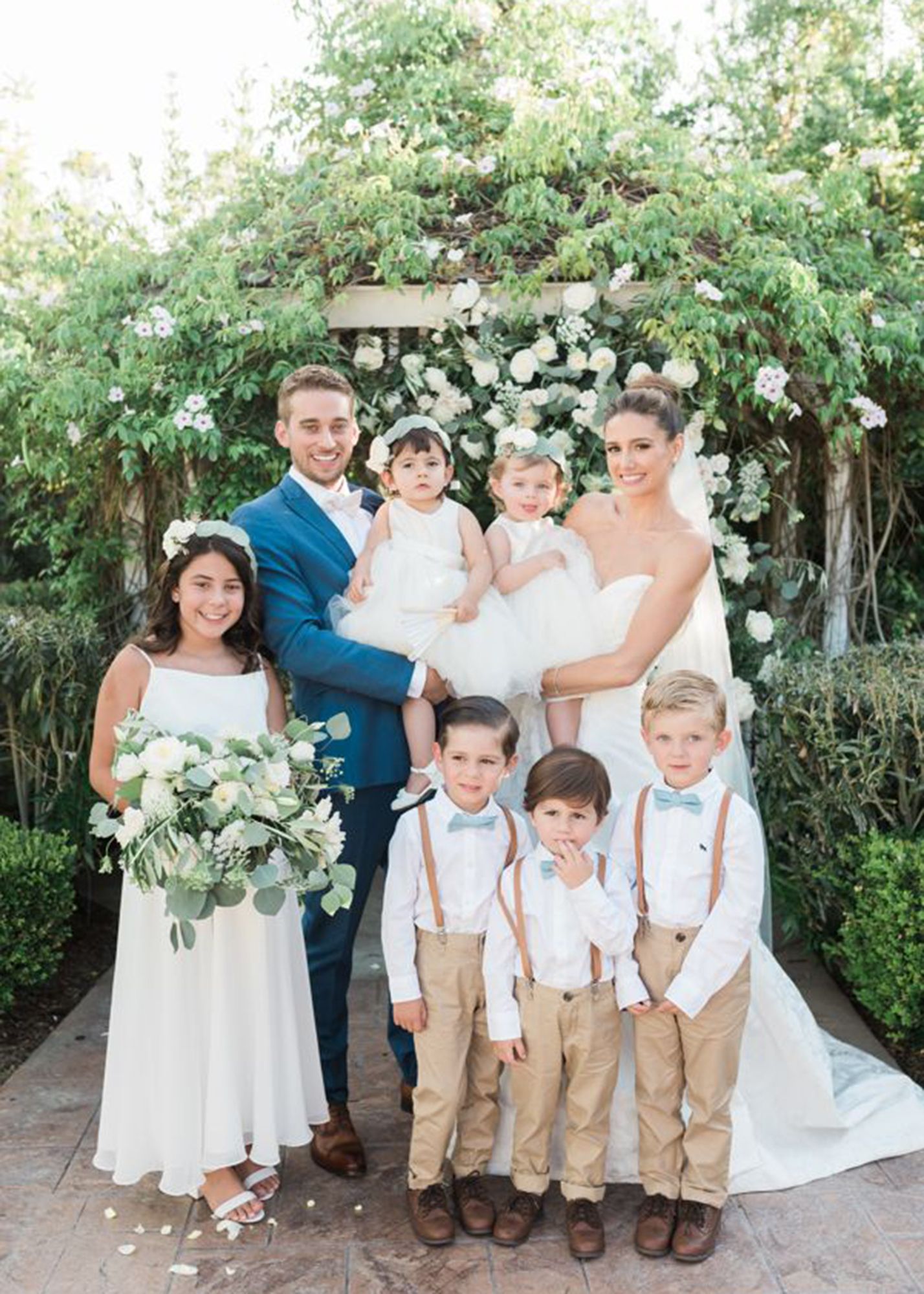 photo of a groom in a blue suit and bride with six children and toddlers