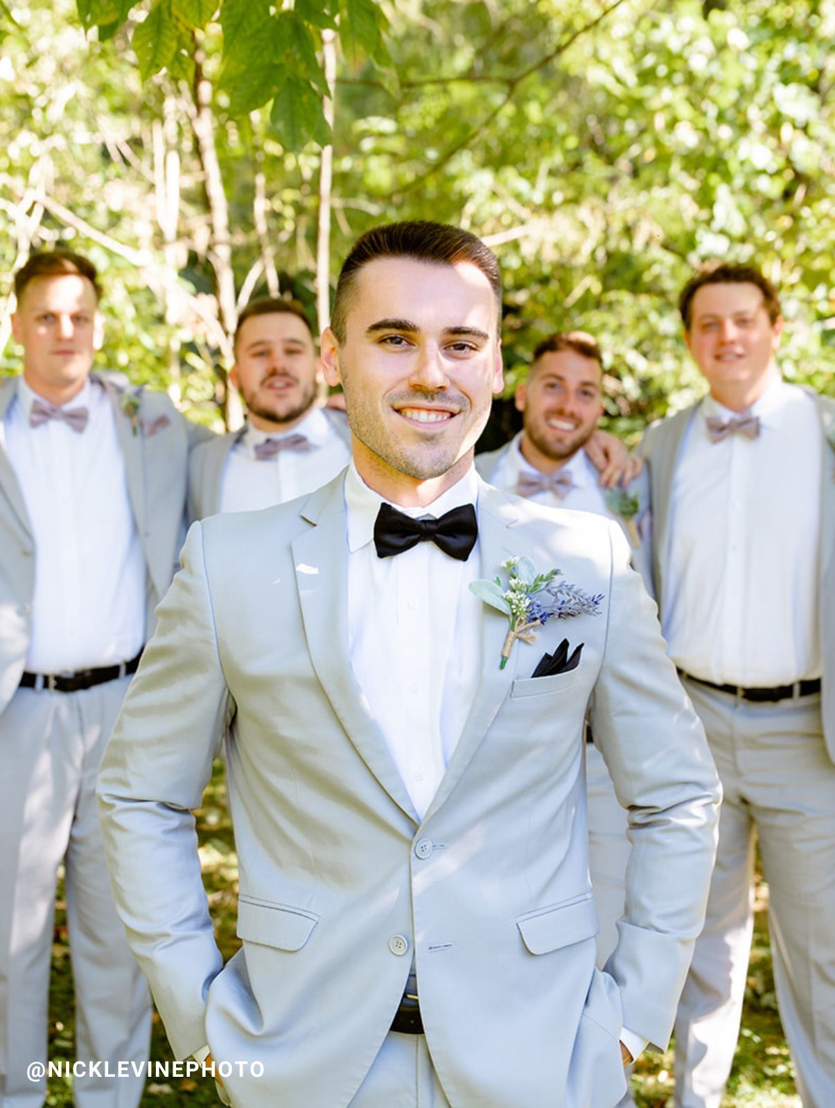 groomsmen holding the groom in gray suits