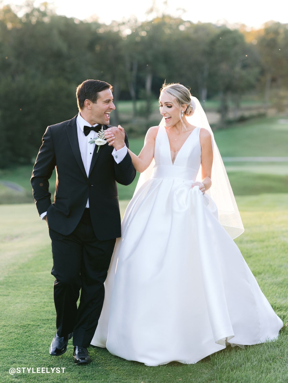 Groom wearing a black tuxedo from Generation Tux with bride