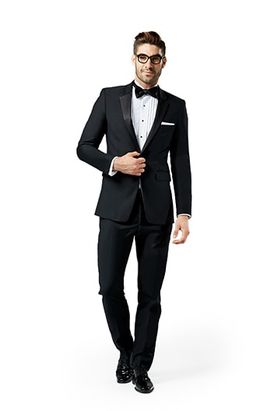 Black notch lapel suit worn in front of a white background.