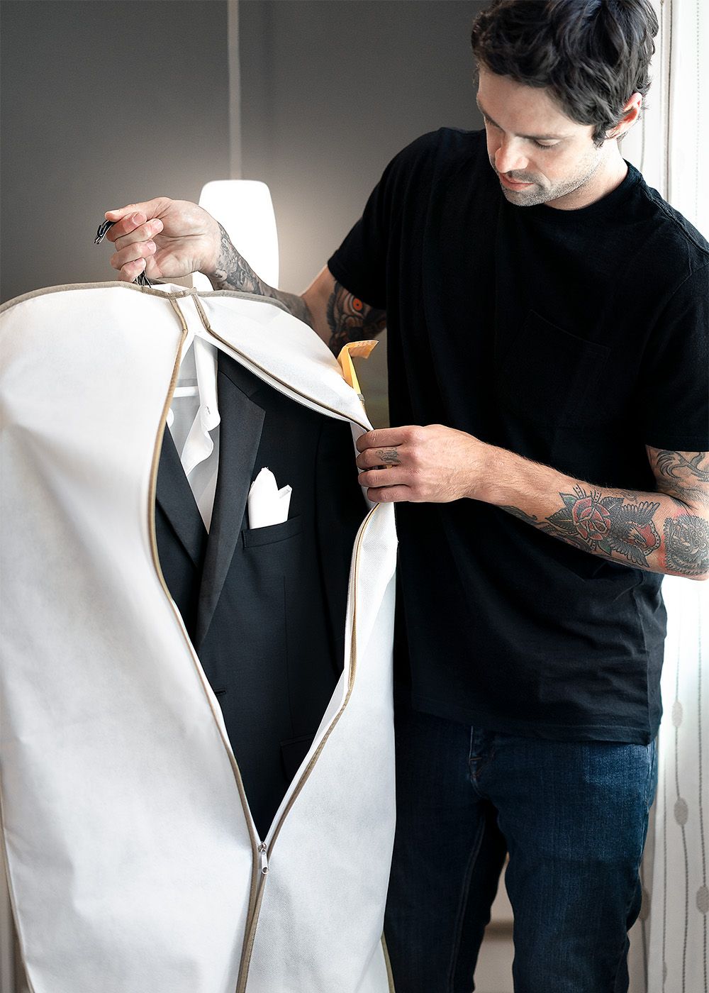 A man unzipping his suit from Generation Tux 