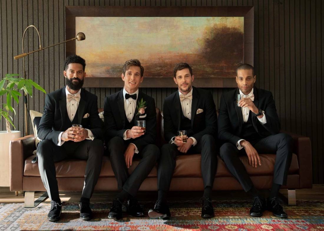Four groomsmen in coordinated Generation Tux tuxedos