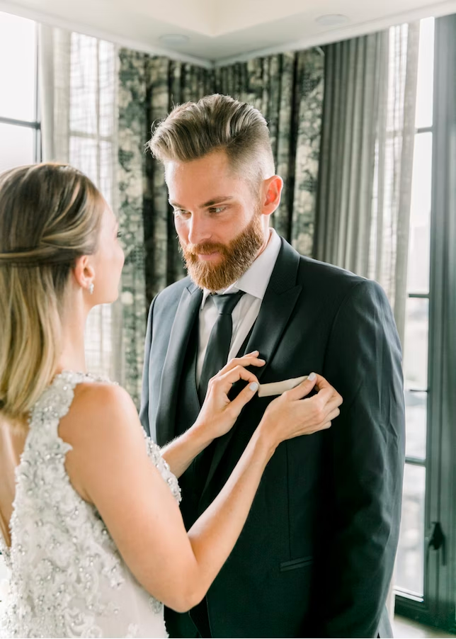bride fixing grooms pocket square