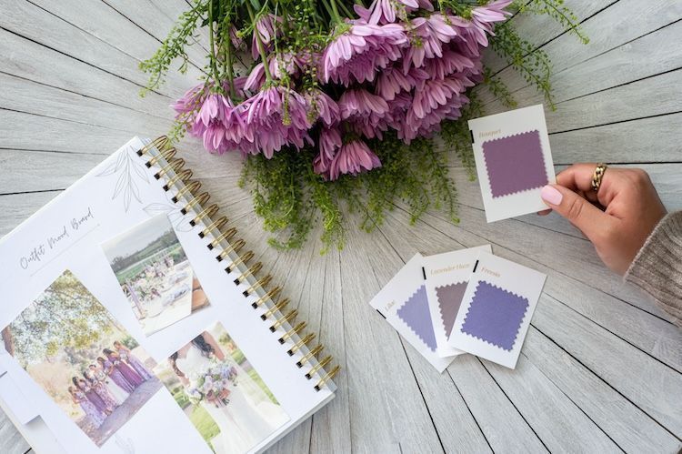 Hand color matching purple swatches with flowers
