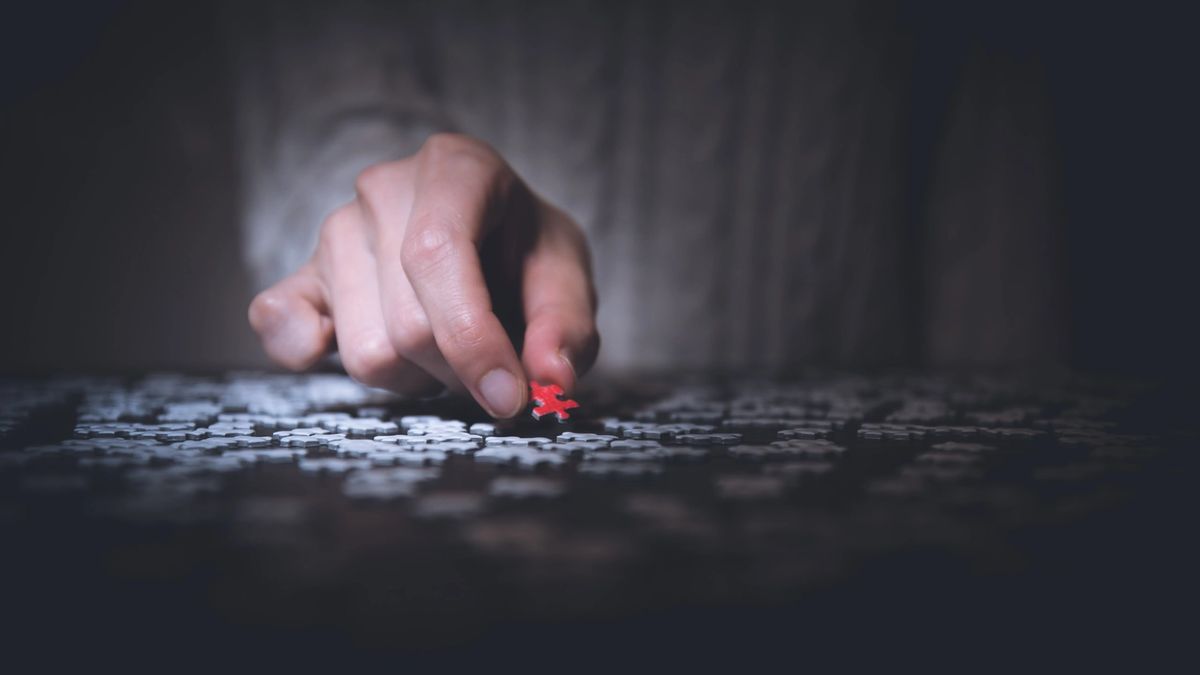 image of a man place a puzzle piece