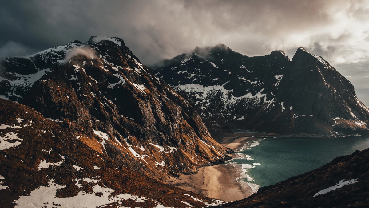 Mountains in cloudly weather with a beach.