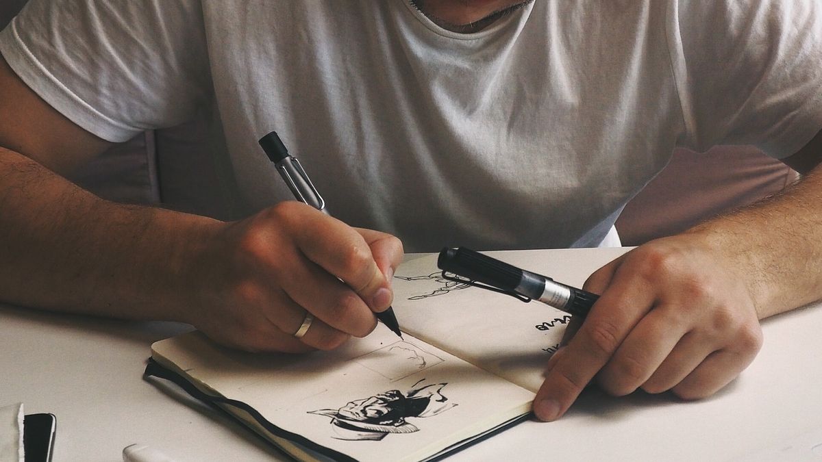 Person drawing at desk