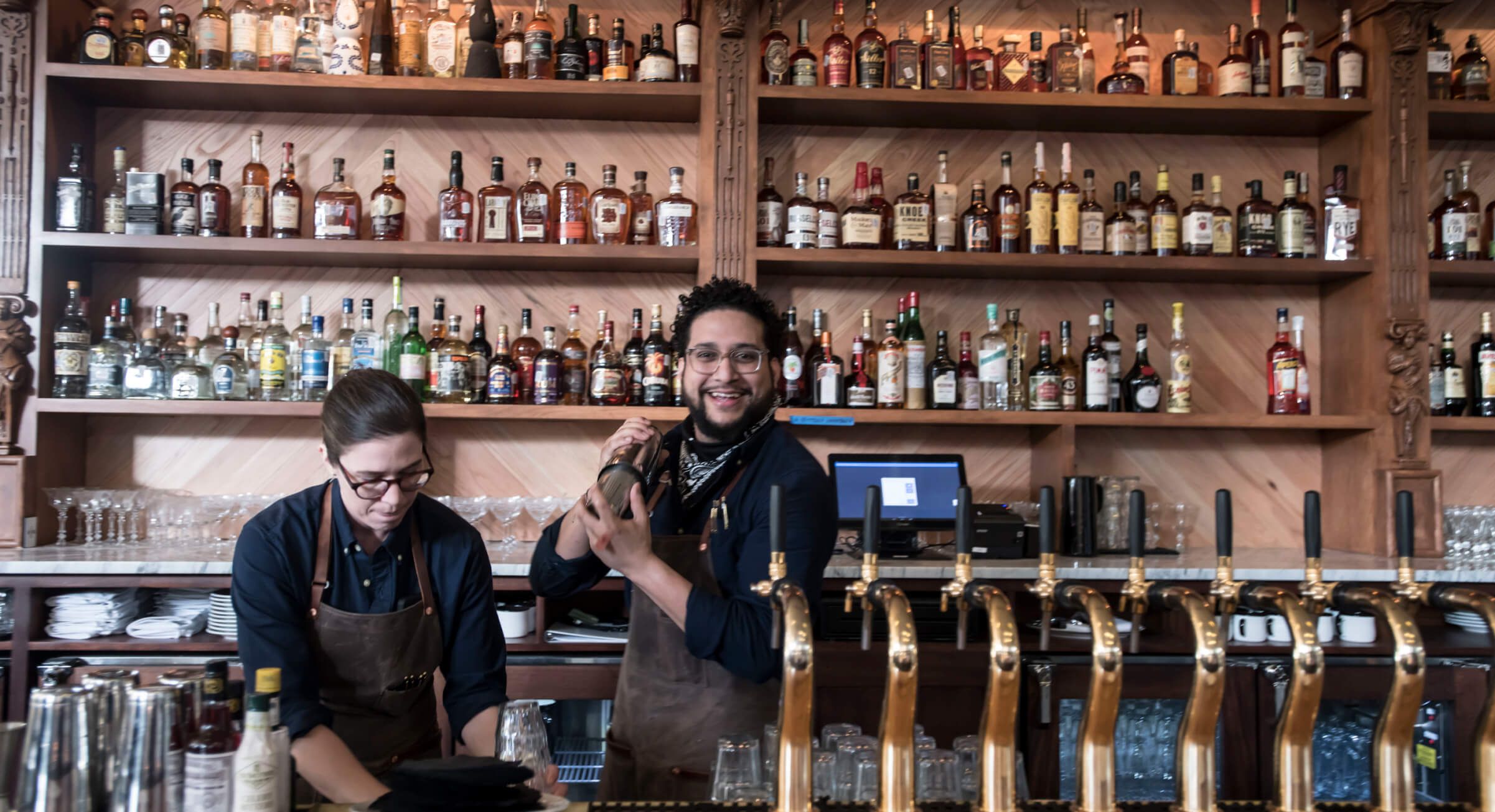 Billy Can Can bartenders behind the bar making drinks