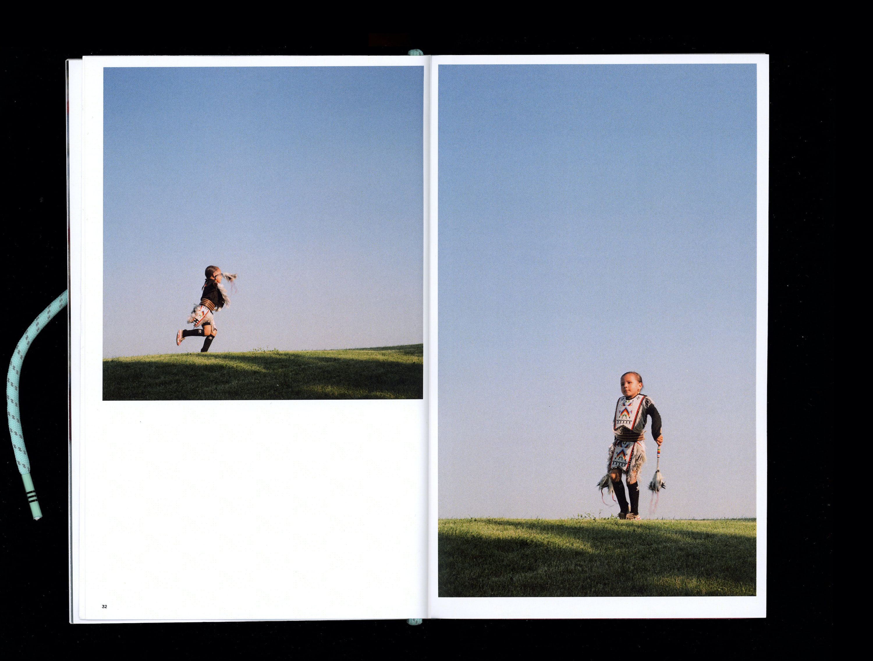 Photograph in book of Tokala Little Sky dancing on grass field with blue sky in the background