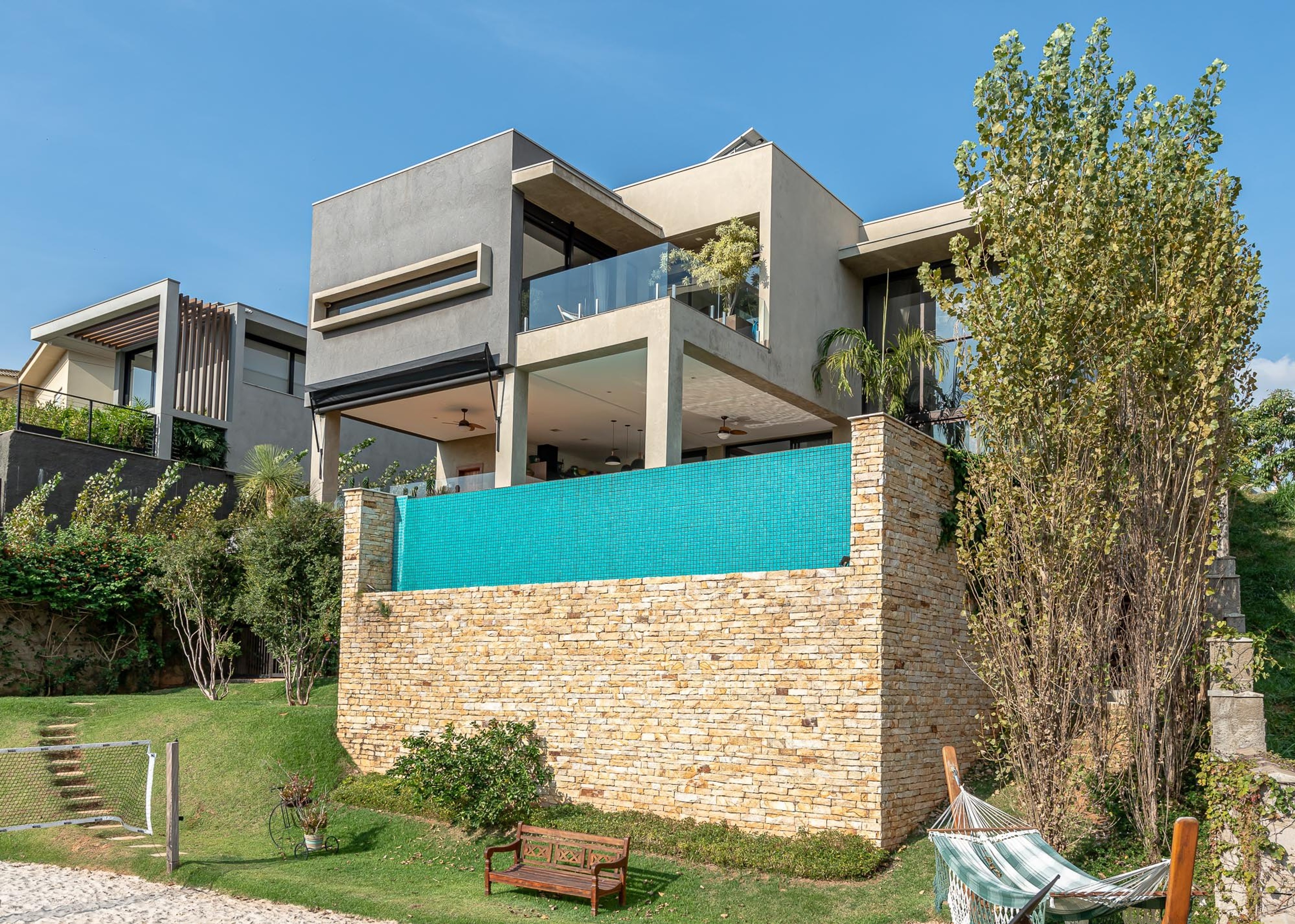 Residência DUA — Fachada lateral com piscina elevada