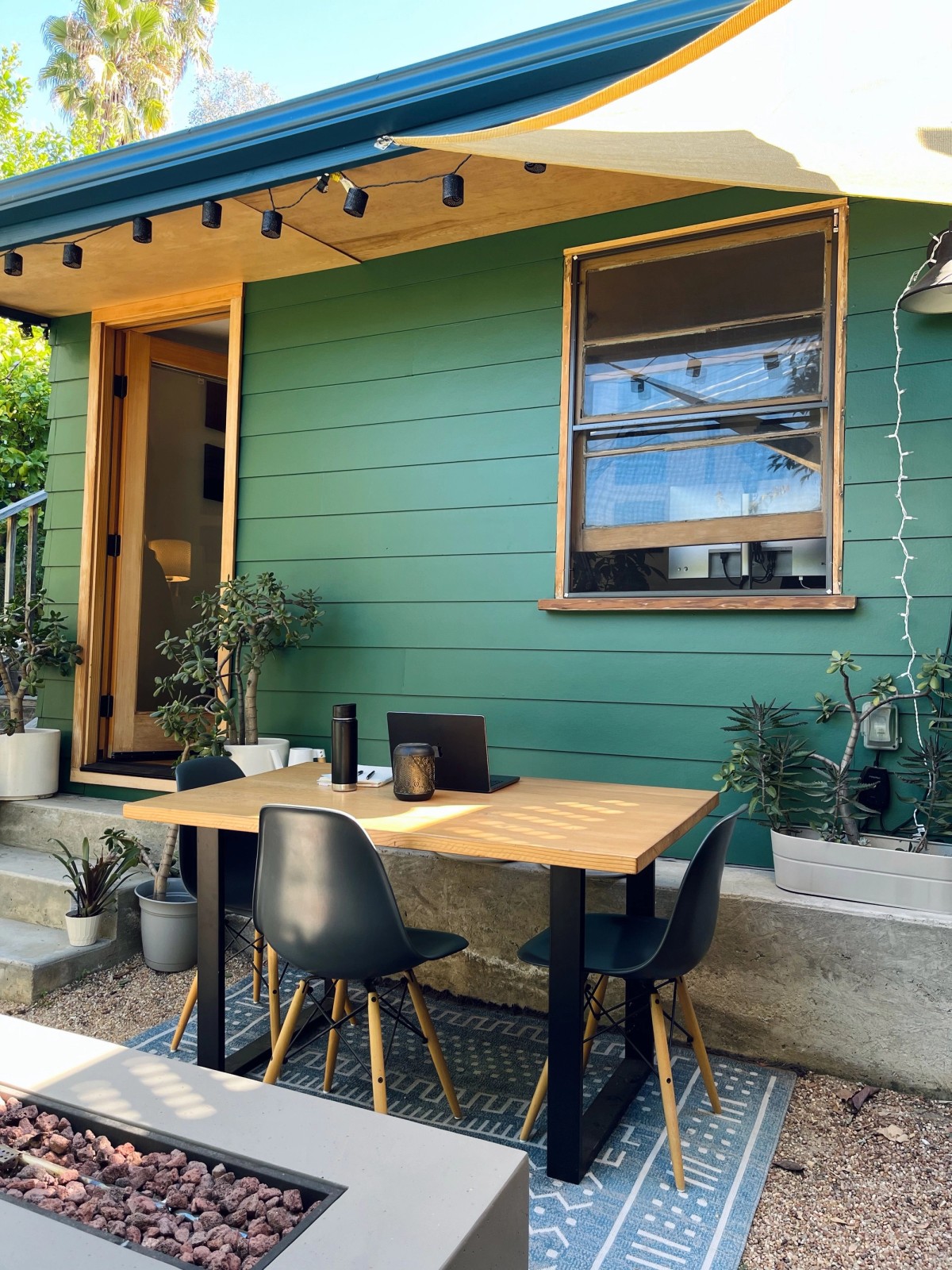 Patrick Morgan outdoor workspace with table and fire pit in Southern California sunshine