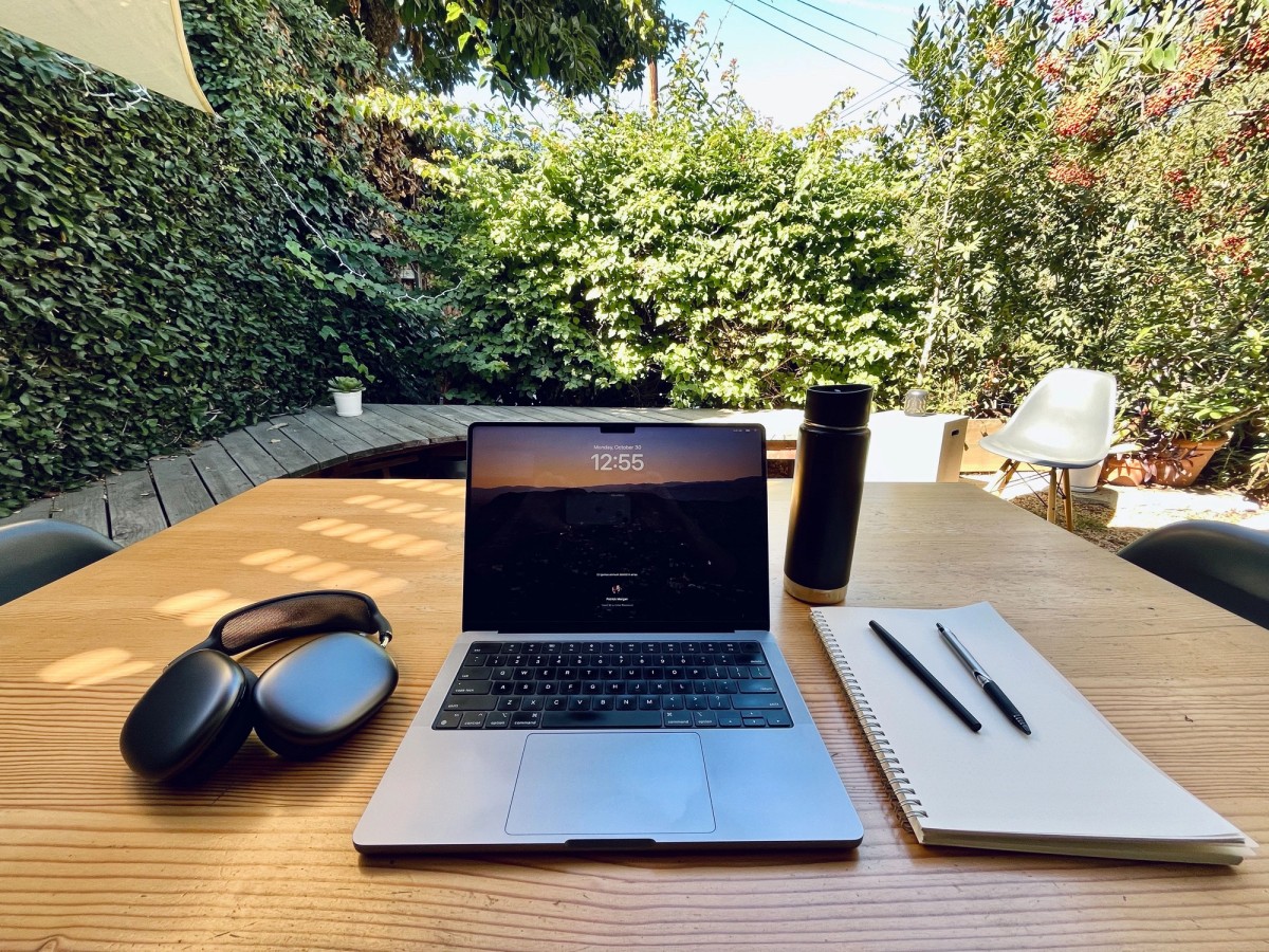 Patrick Morgan working outdoors on MacBook Pro with AirPods Max in Southern California