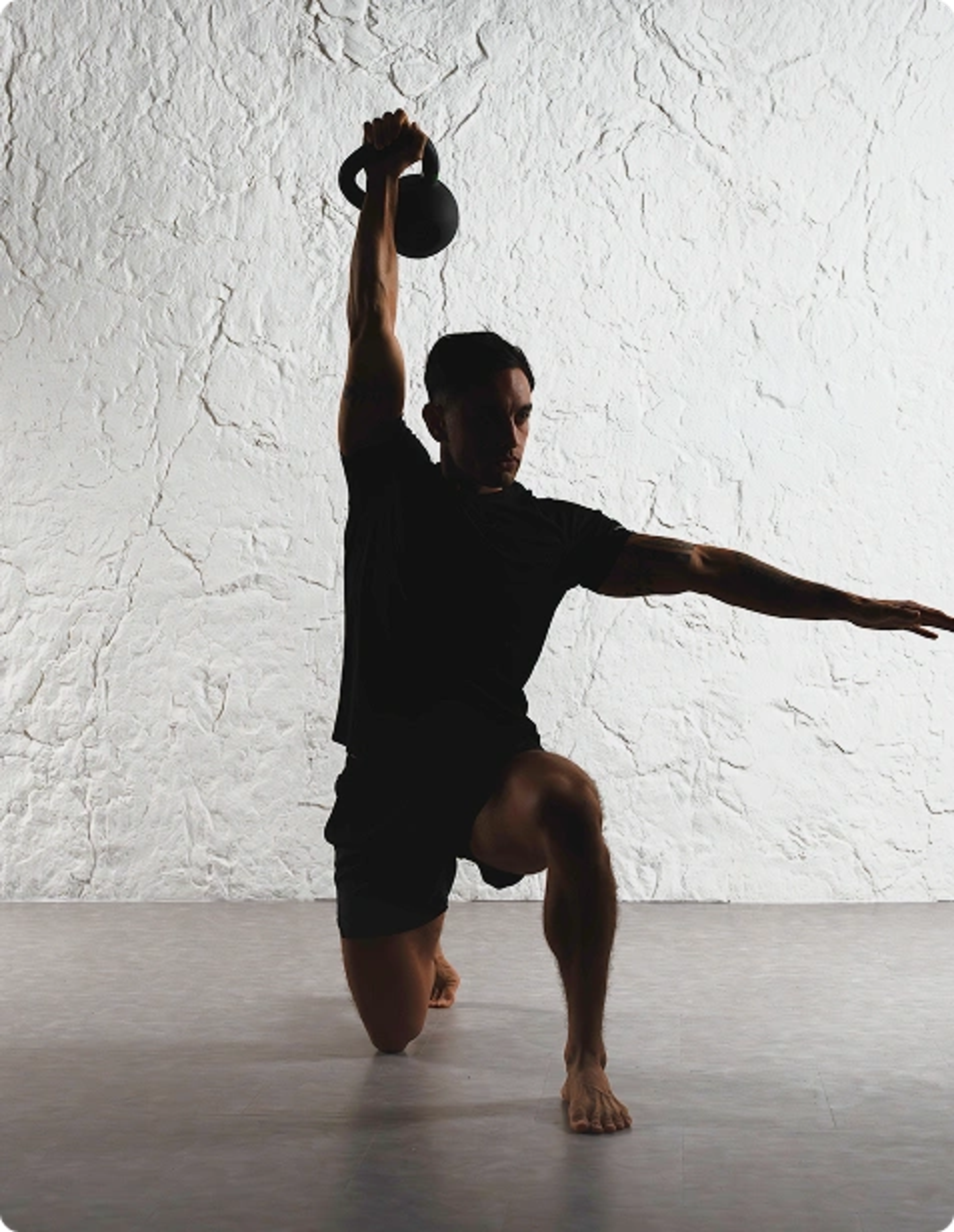 man with kettle bell above head