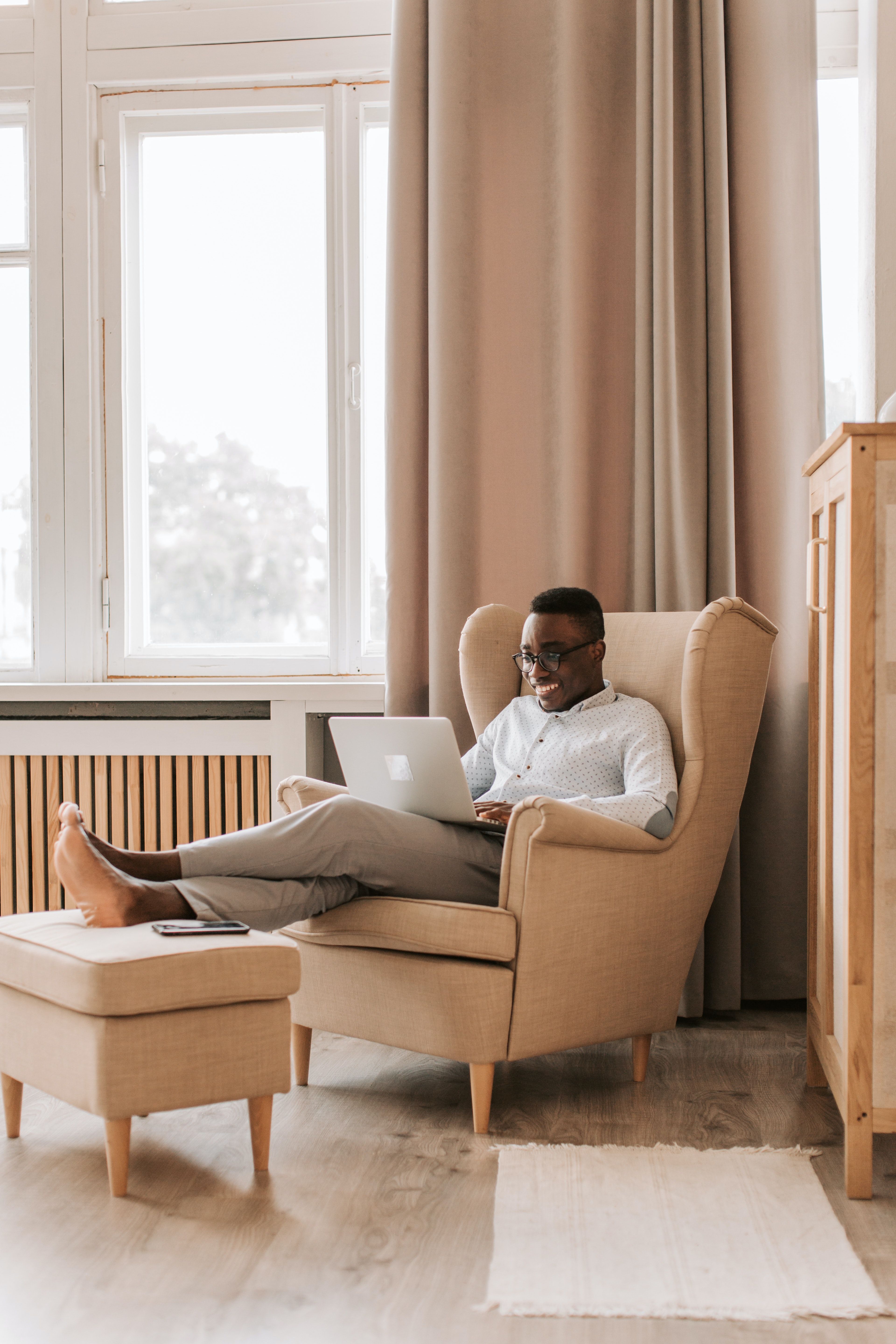 Image of person sitting on chair with laptop