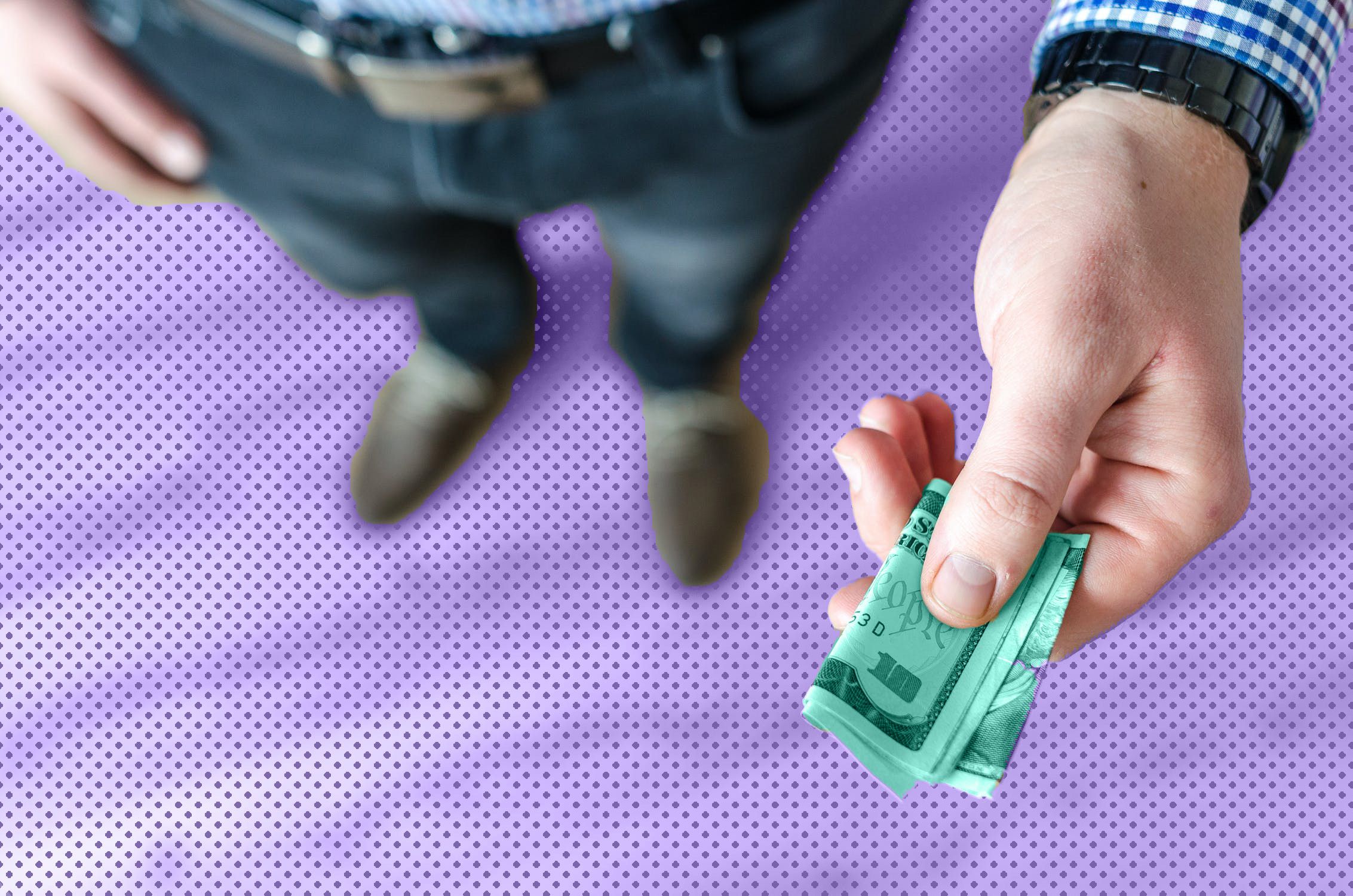 A man holding a ten-dollar bill