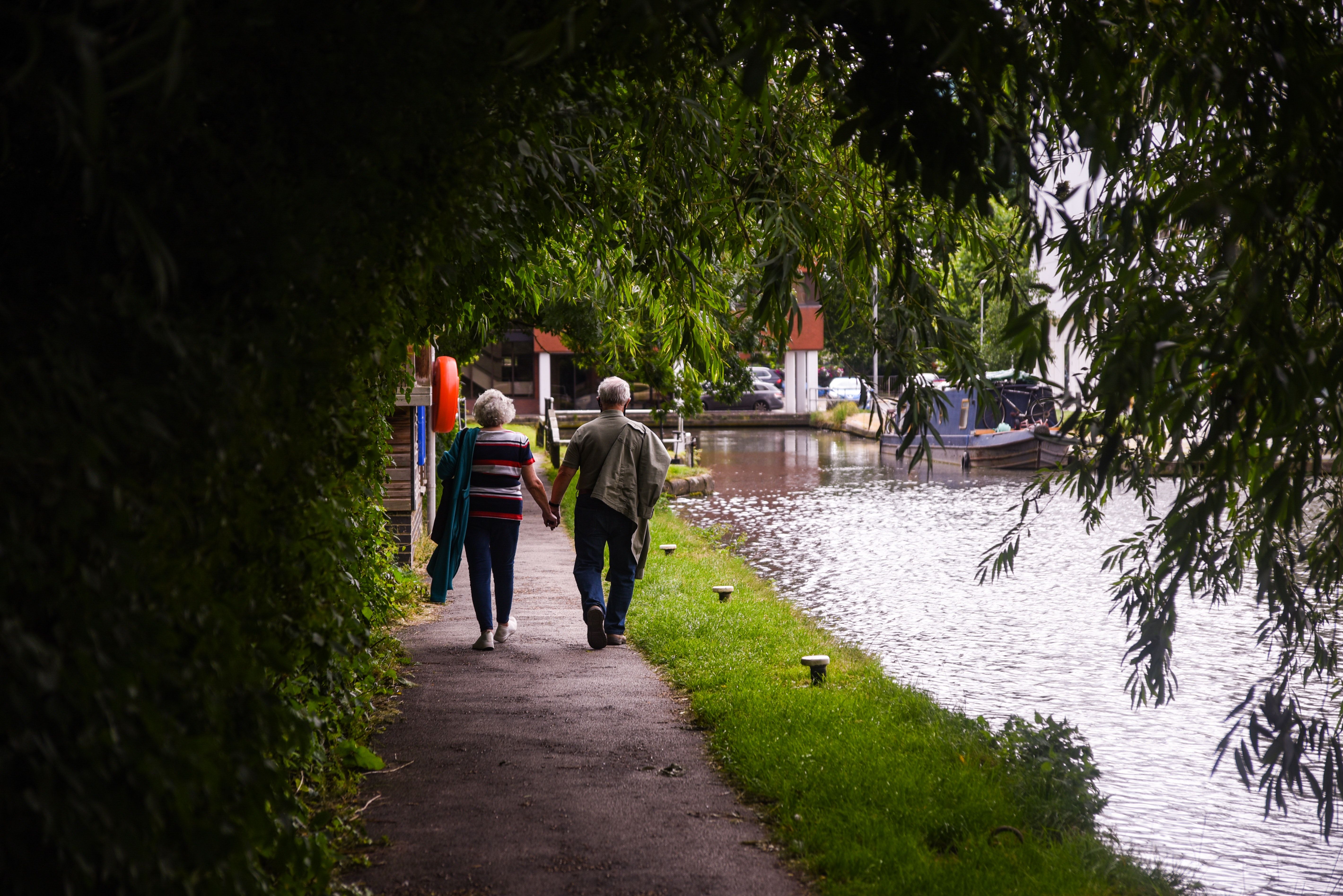 Elderly couple walking by the river