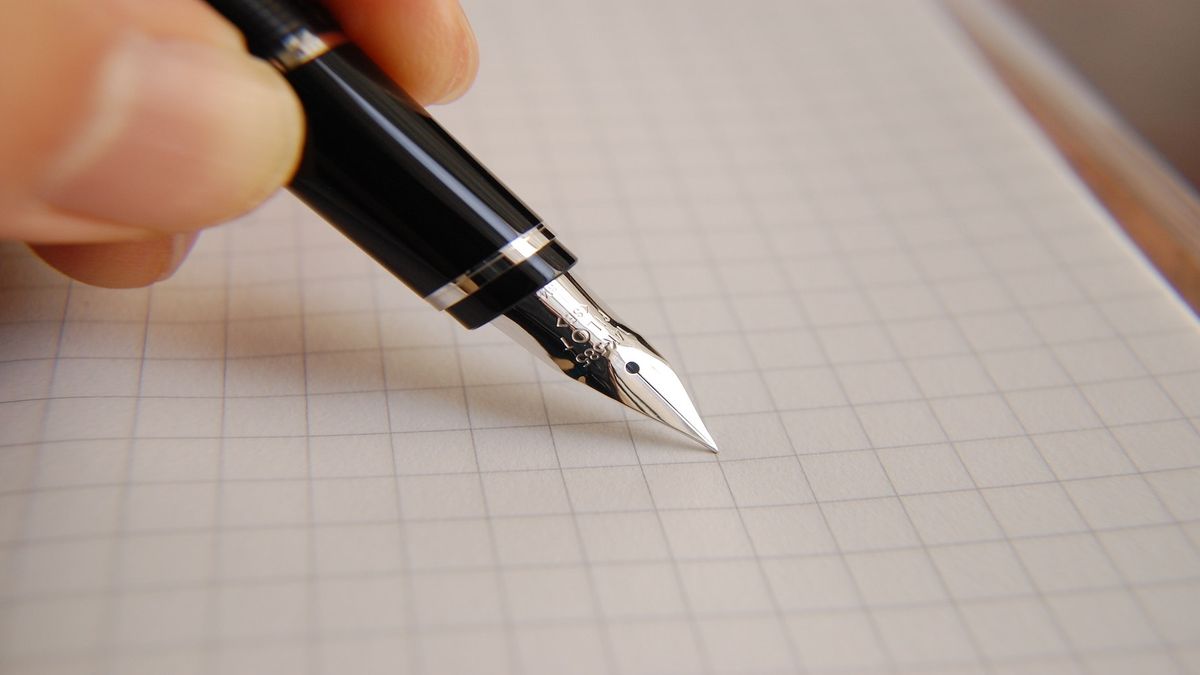 Pen writing on graph paper.