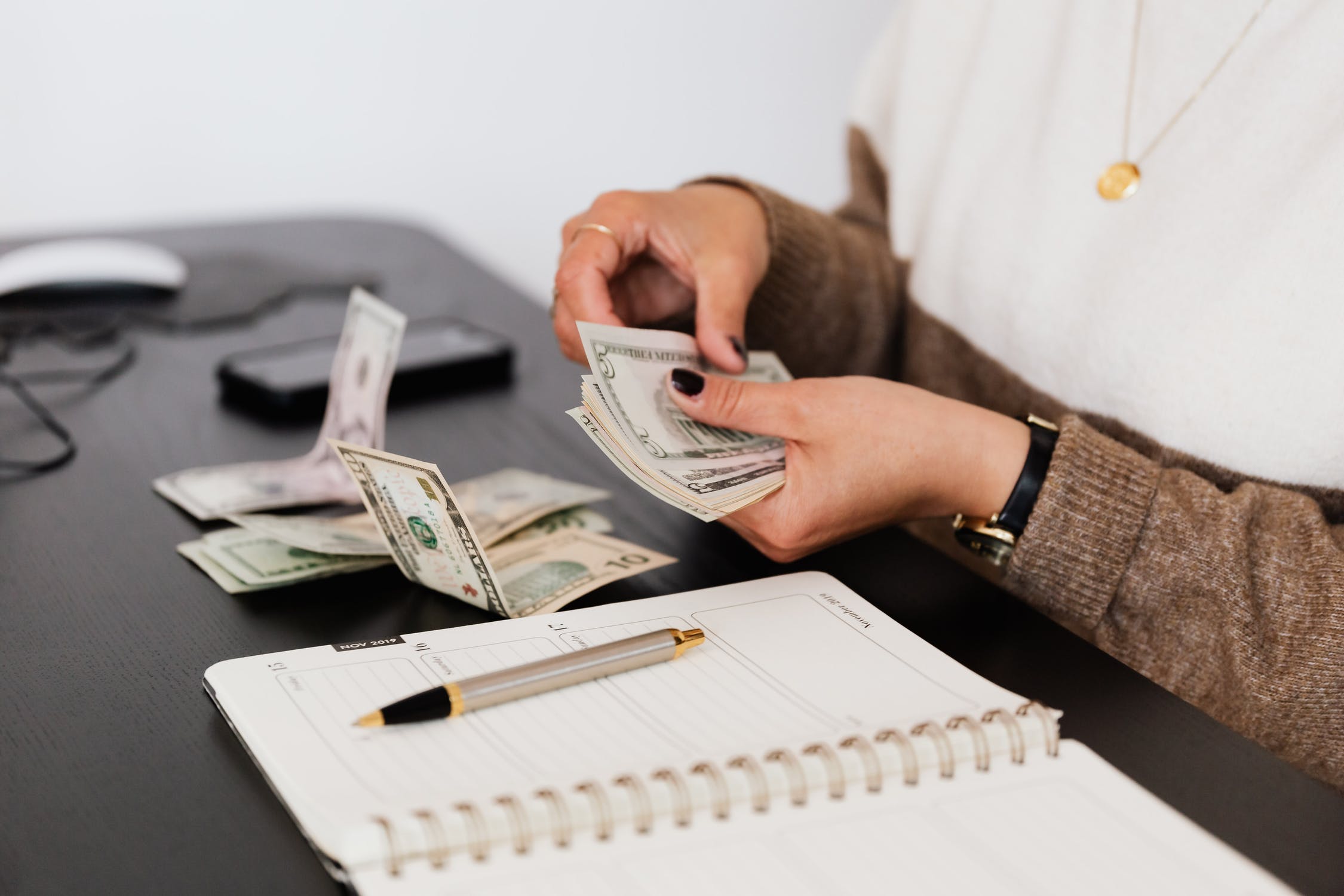 An image of a payroll clerk counting money