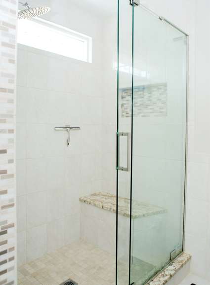 Shower detail with modern tile design and glass doors in Columbia, MD