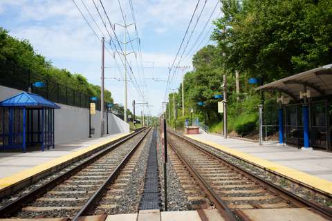MTA Linthicum station view of tracks with new pavilions on north and south-bound platforms and retaining wall on west side. Linthicum Heights, MD.