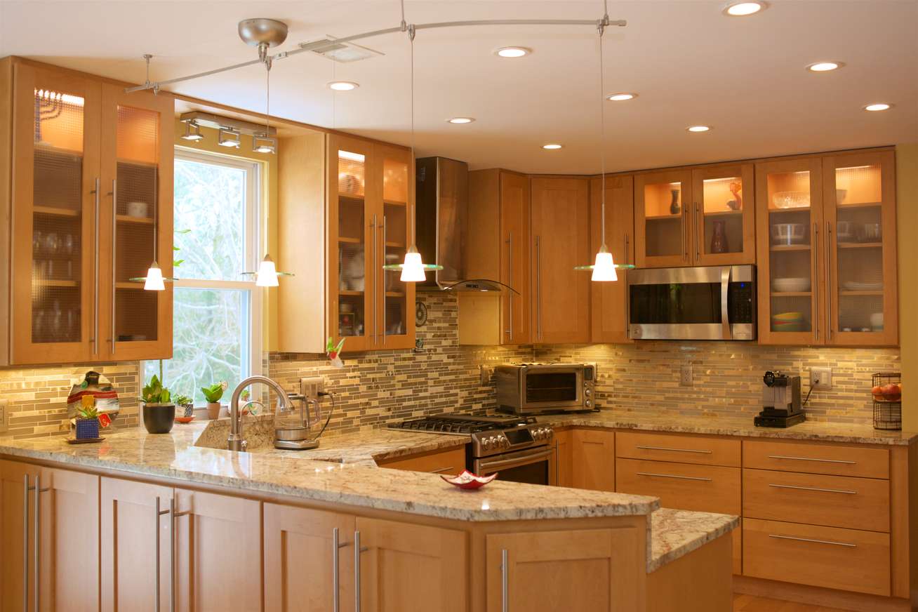 Birdwatcher's Delight in Columbia, MD contemporary kitchen renovation design featuring modern lighting, granite countertops, wood cabinetry and improved storage