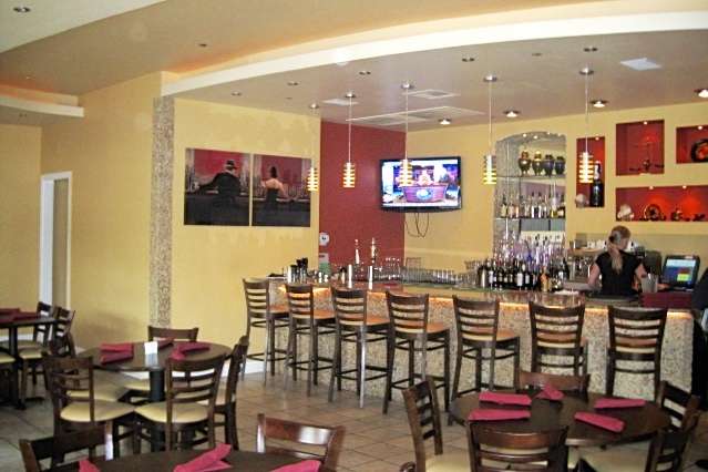 Nostalgia Bistro in Rockville, MD bar view from main dining area featuring ceiling and lighting detail