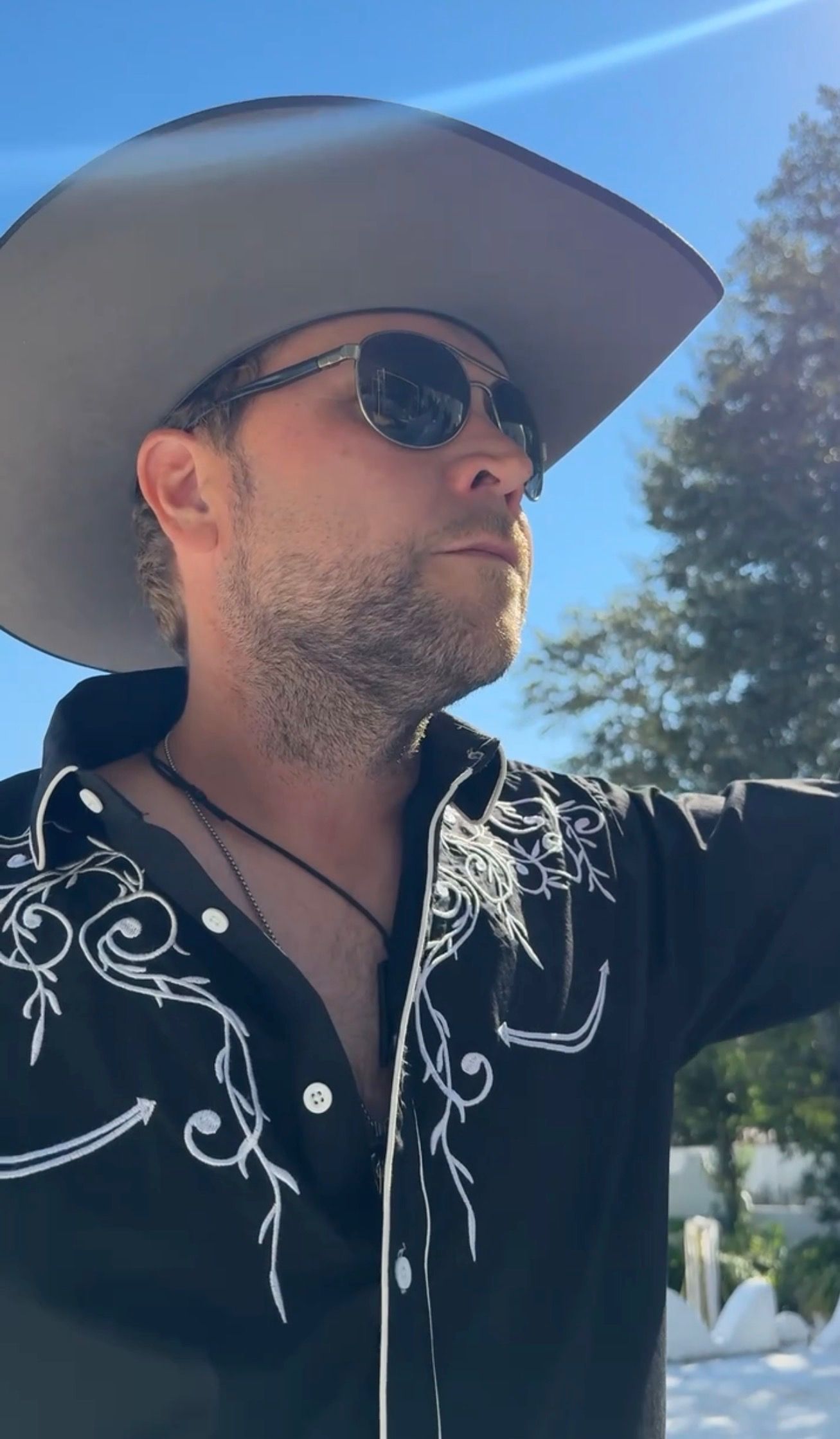 A guitarist in western stagewear during the outdoor “Mexico” video shoot