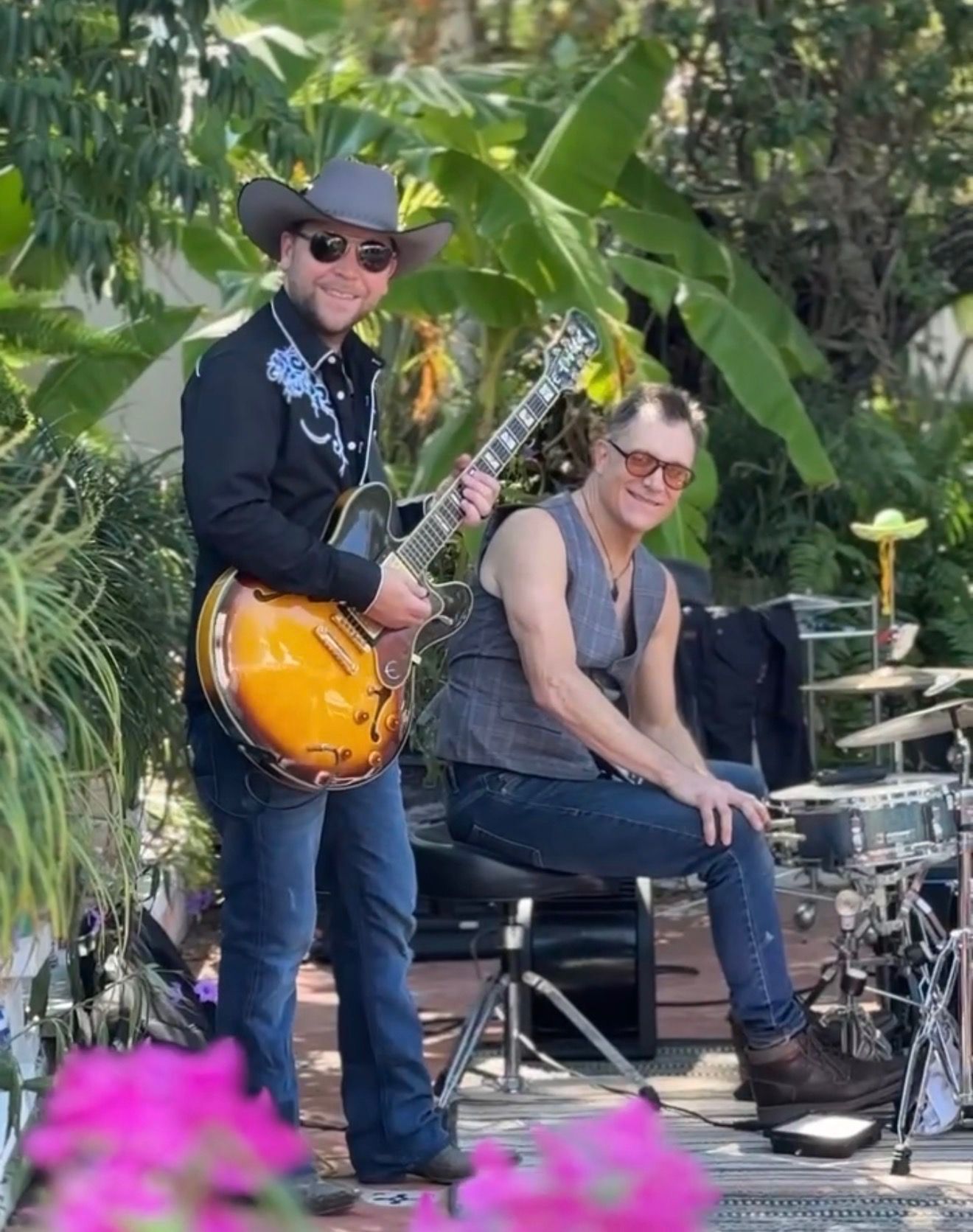 Guitarist and drummer between takes on the tropical villa set