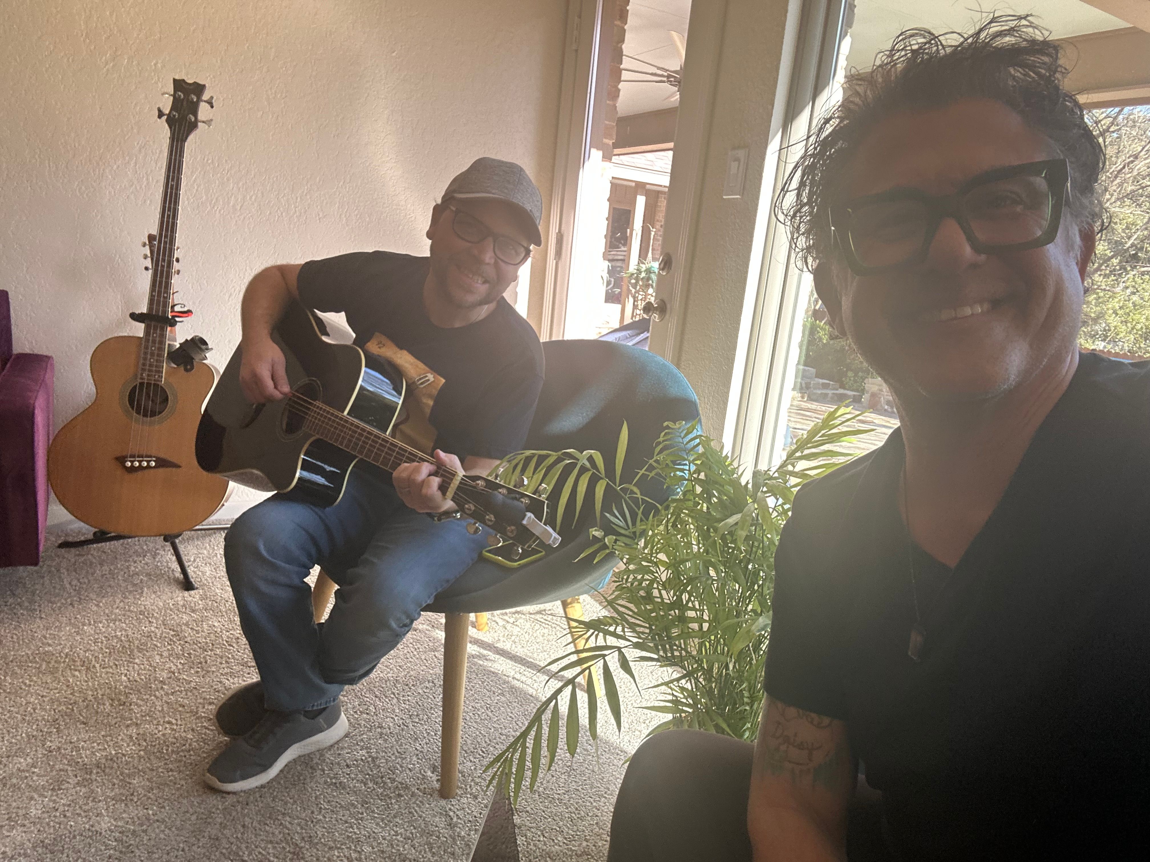 Two musicians sharing an early acoustic jam session at home