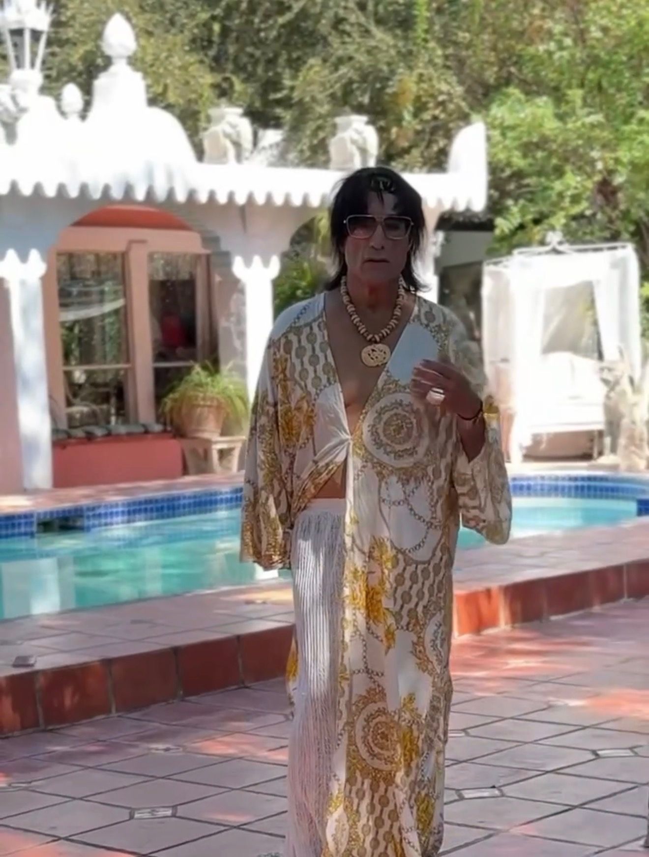 A costumed performer beside the pool at the Spanish-style villa during the “Mexico” video shoot