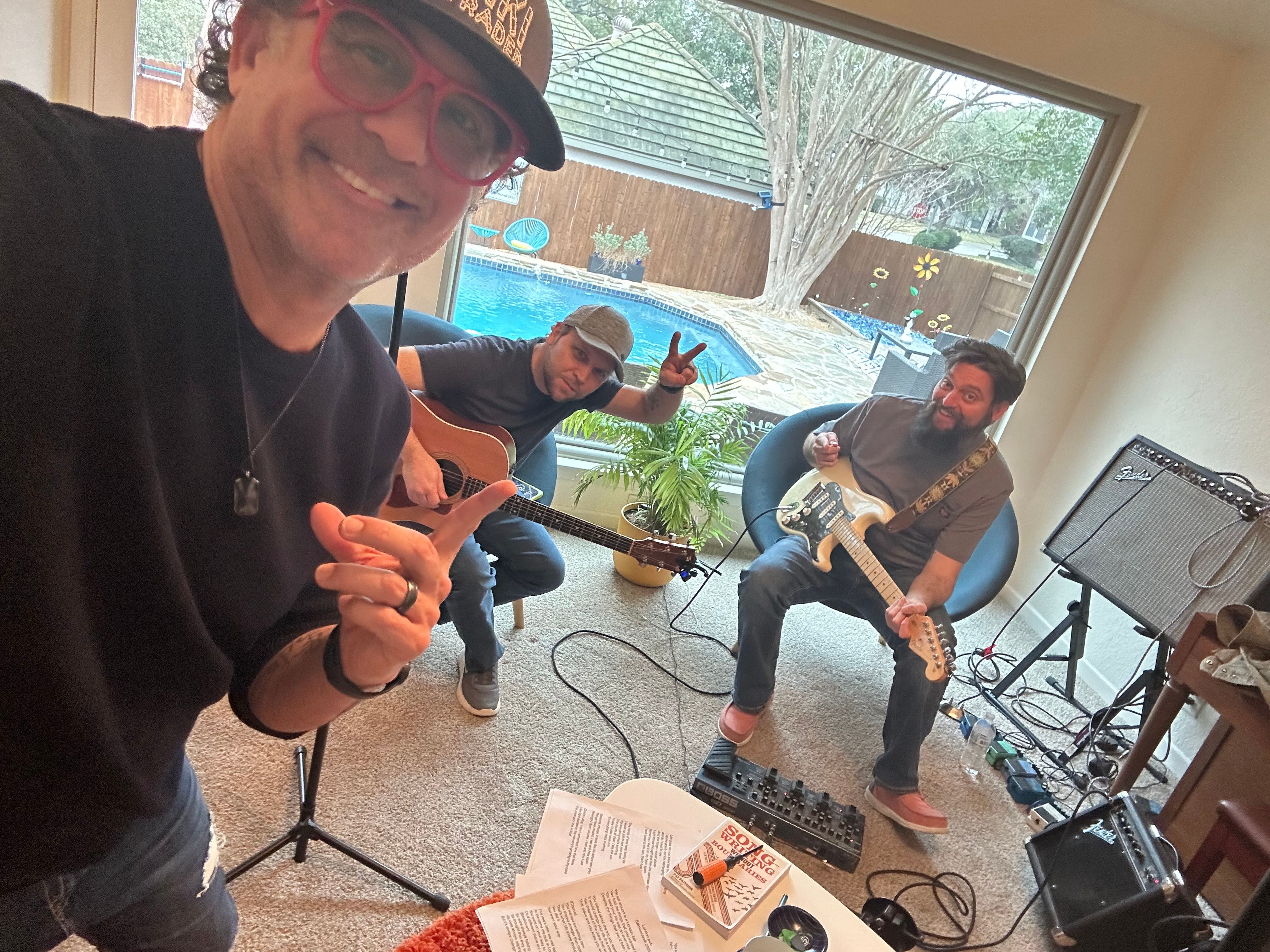 Jet Lag Motel musicians rehearsing together with acoustic and electric guitars