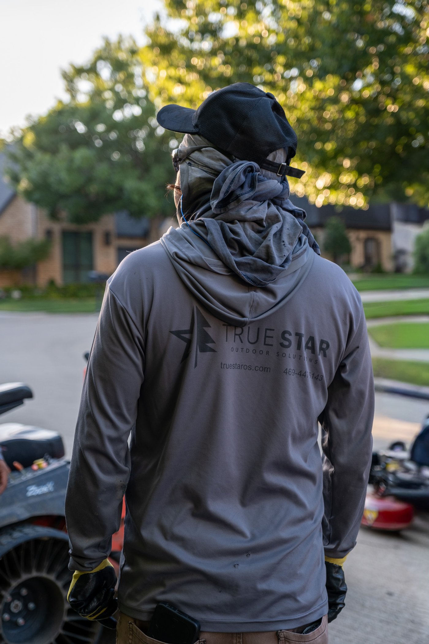 True Star crew member in branded gear at community property