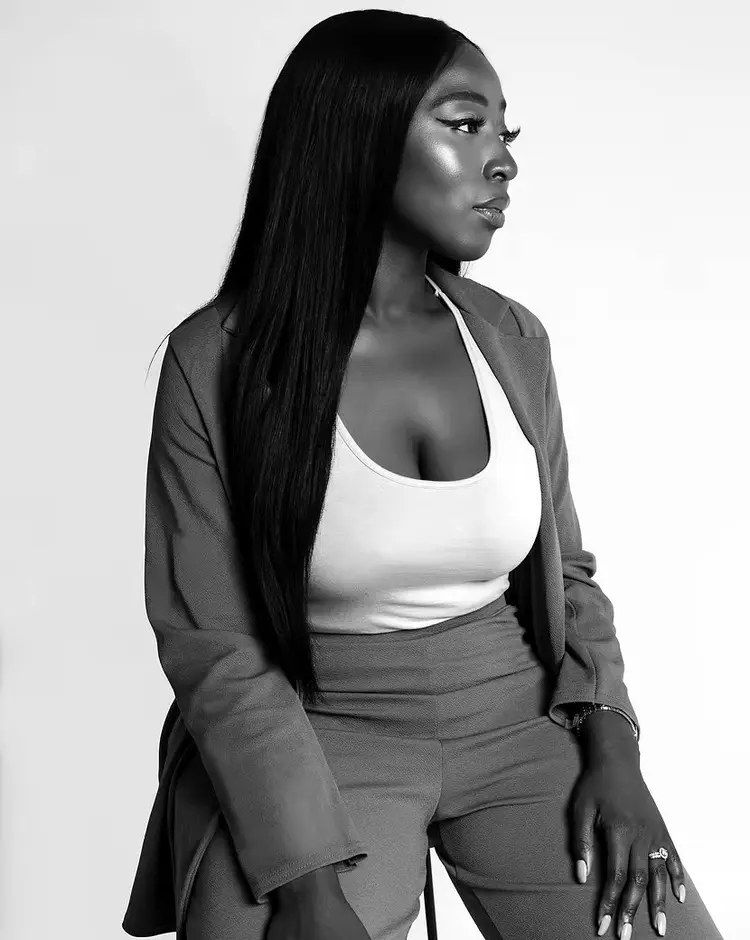 Yvonne Bajela, seated, in black and white