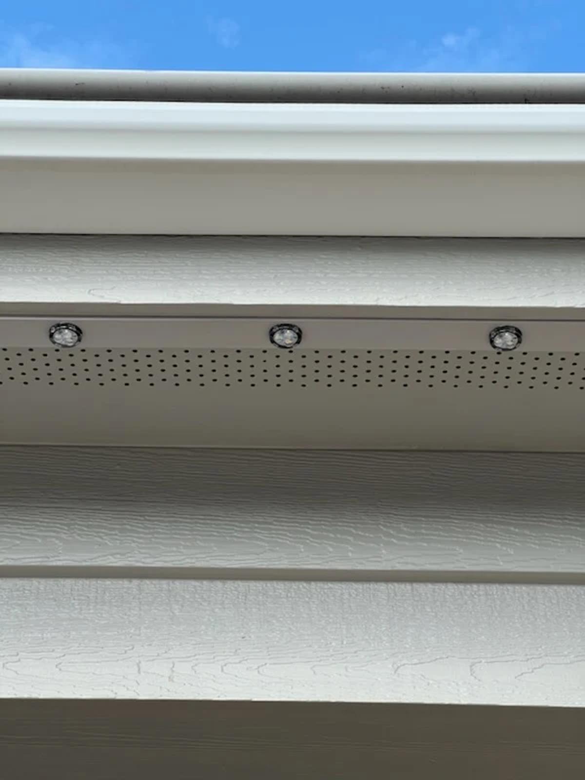 Close-up of permanent LED outdoor lighting installed along a home's roofline
