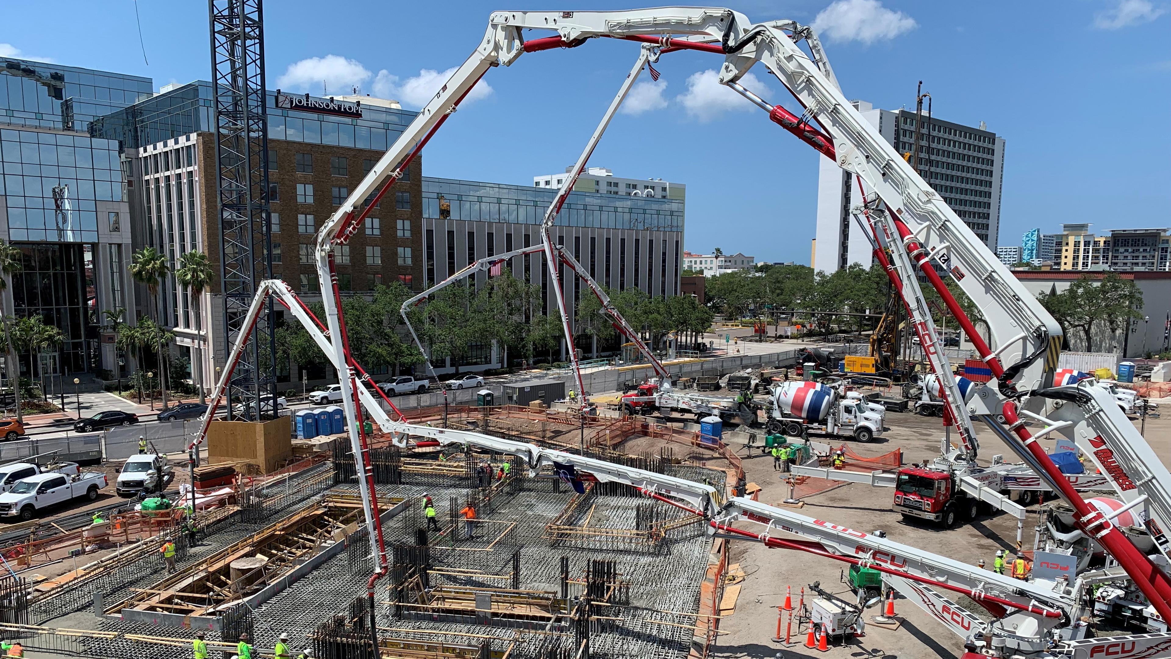 a large crane structure erected to begin a concrete pour for a residential foundation