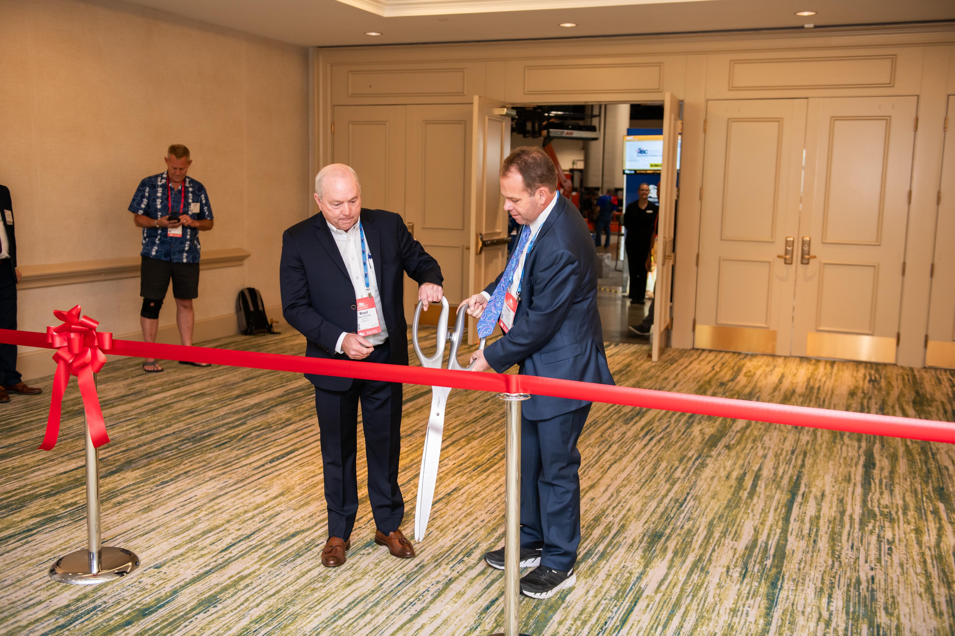 ABC 2024 National Chair Buddy Henley cuts the ribbon to the exhibit hall and competition floor.